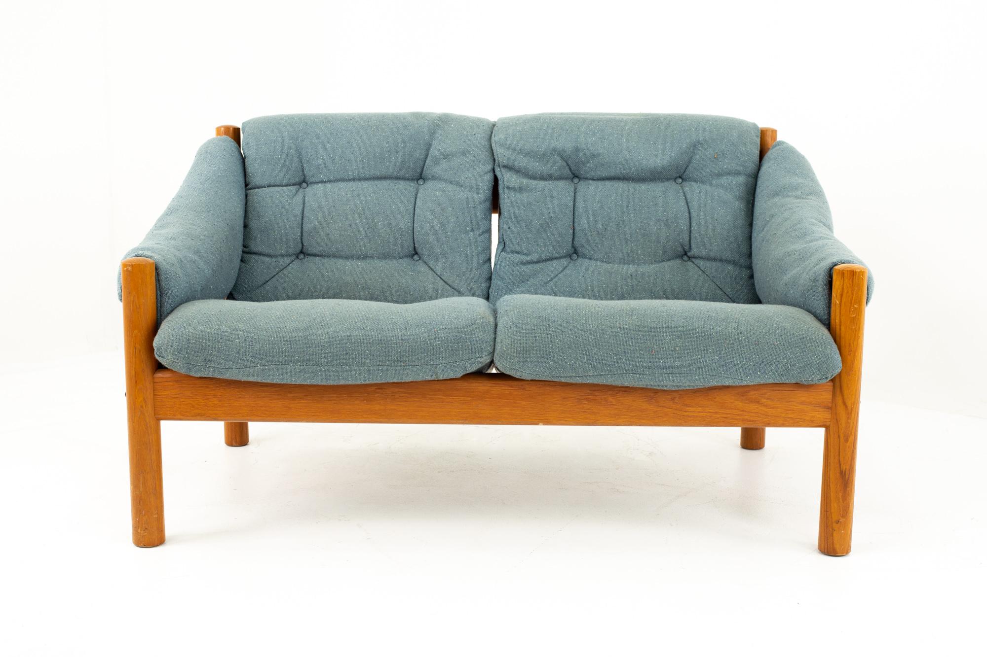 Mid Century Modern Teak and Blue Upholstered Sofa
Couch measures: 51 wide x 29 deep x 29 high

This piece is available in what we call Restored Vintage Condition. Upon purchase it is thoroughly cleaned and minor repairs are made - all of this is