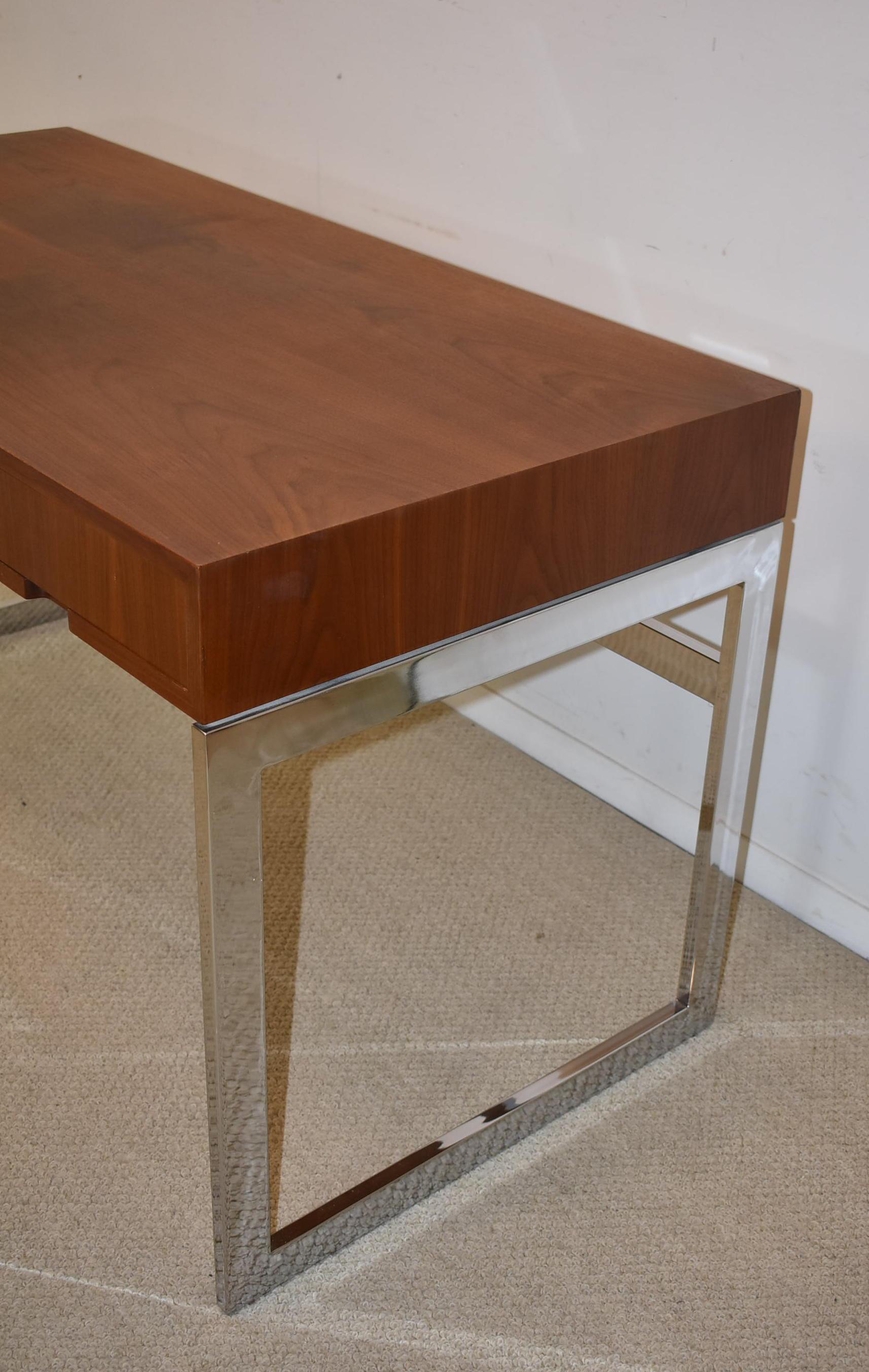 Mid-Century Modern three-drawer desk with chrome-plated frame with teak top. Drawers are lined in mahogany.