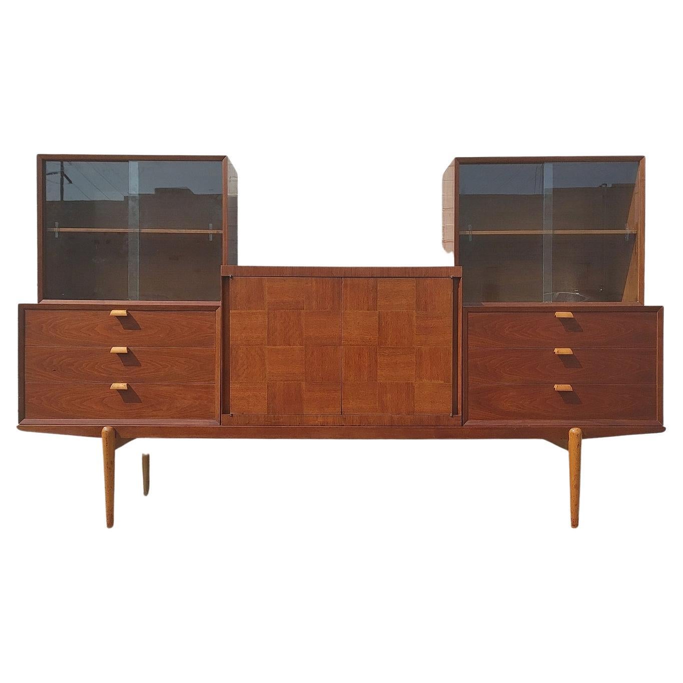 Mid Century Modern Teak and Oak Modular Wall Unit

Average vintage condition and structurally sound. Has some expected finish wear and scratching. Very unique piece offering options on placement of five cabinets. Checkered cabinet has rings and some
