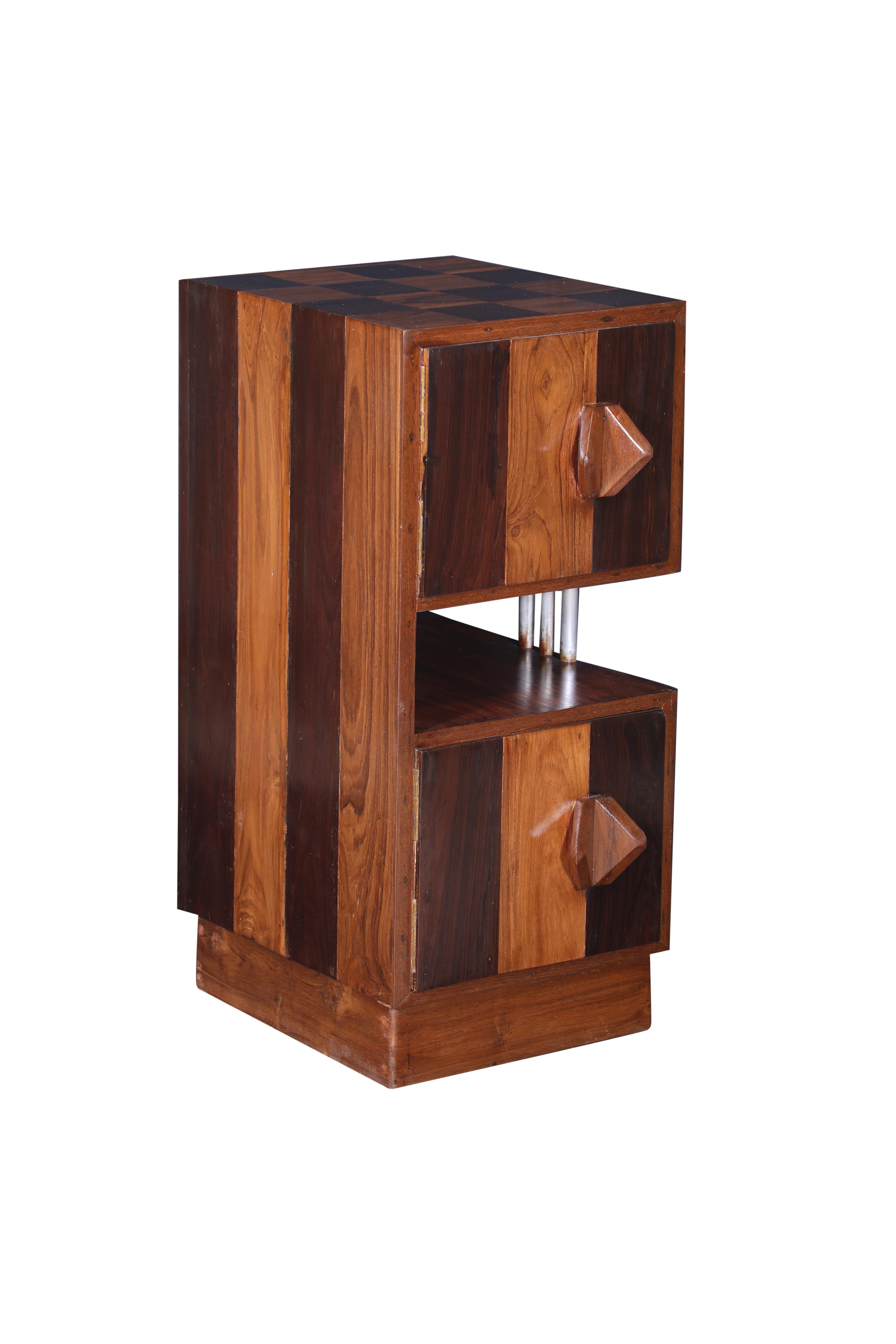 Mid Century Modern teak and rosewood side or end table cabinet.  It features a striped pattern along the sides and a checker board pattern on the top.  The two cabinet doors have butterfly shaped door pulls and chrome bar accents create the shelf