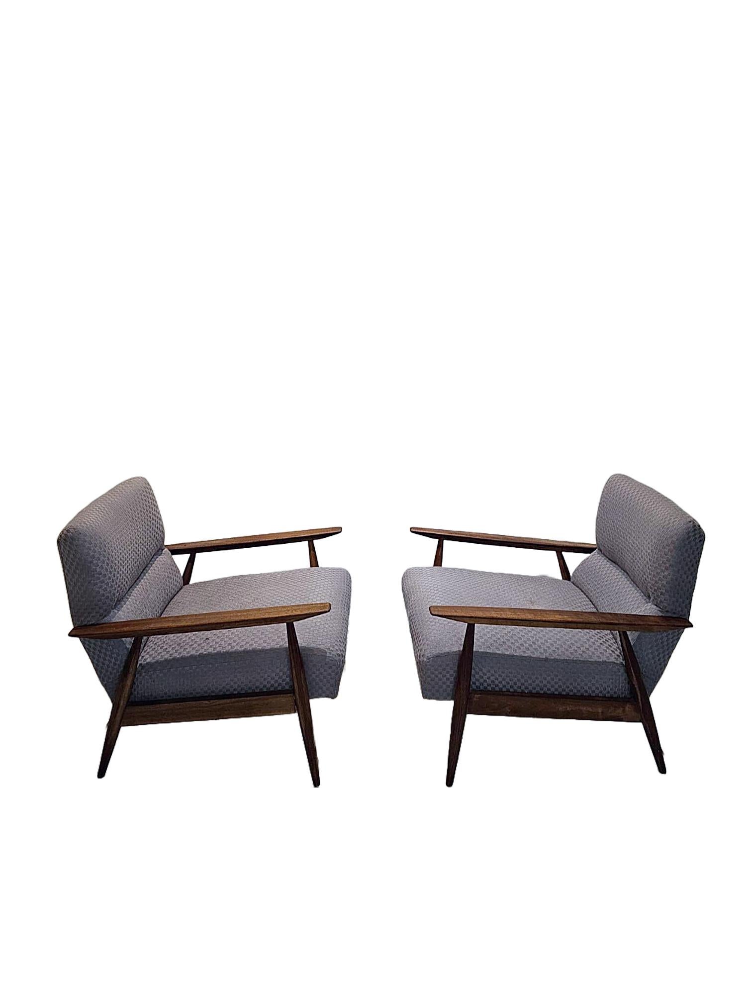This unique armchair set will fit perfectly in any modern or retro setting. Has the original fabric in good condition and is extremely sturdy and comfortable. The back rest is has a smart bend in the design signalling a very well made piece of