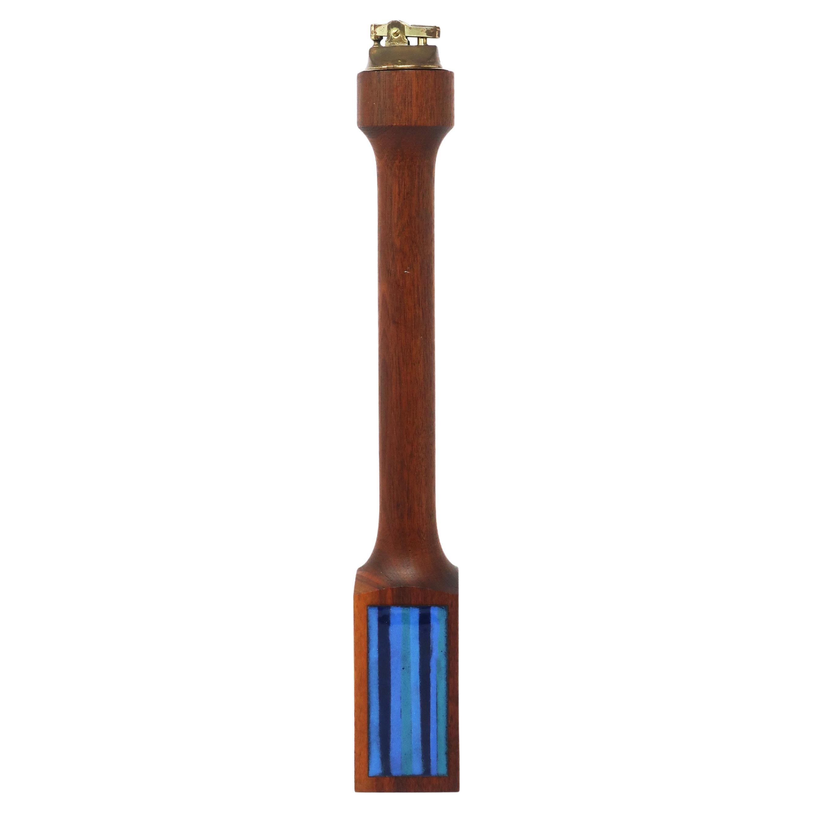 A stunning sculptural mid-century or Scandinavian modern turned teak table lighter with blue enameled accent on the base.  Beautiful as both a decorative and functional piece.  

In very good vintage condition with new flint and fuel added, so it'll