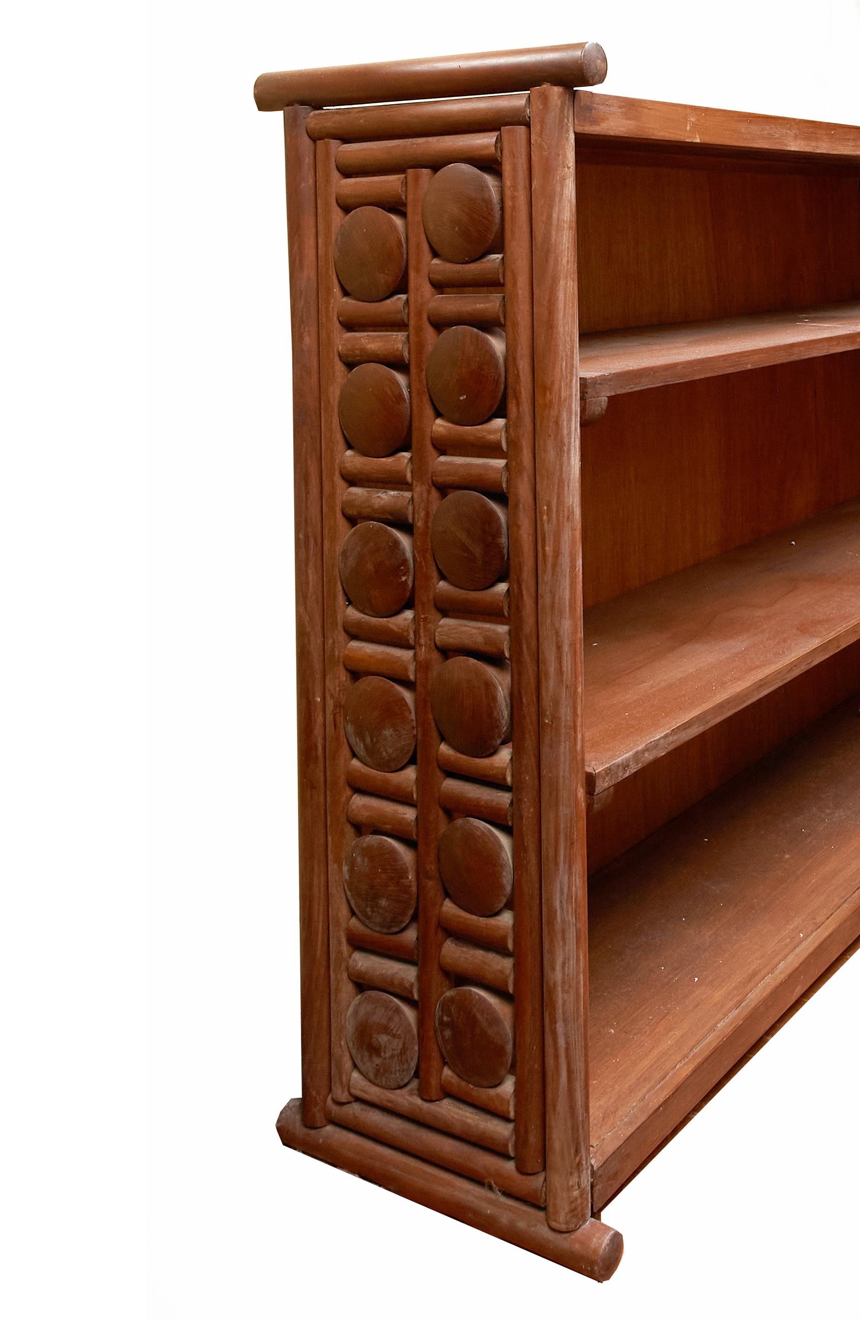 Rare and unique handcrafted solid teak Mid-Century Modern bookcase with floating disk design. The intricately designed sides are a series of teak disks and bars which allows the disks to turn freely while being held in place without nails. This