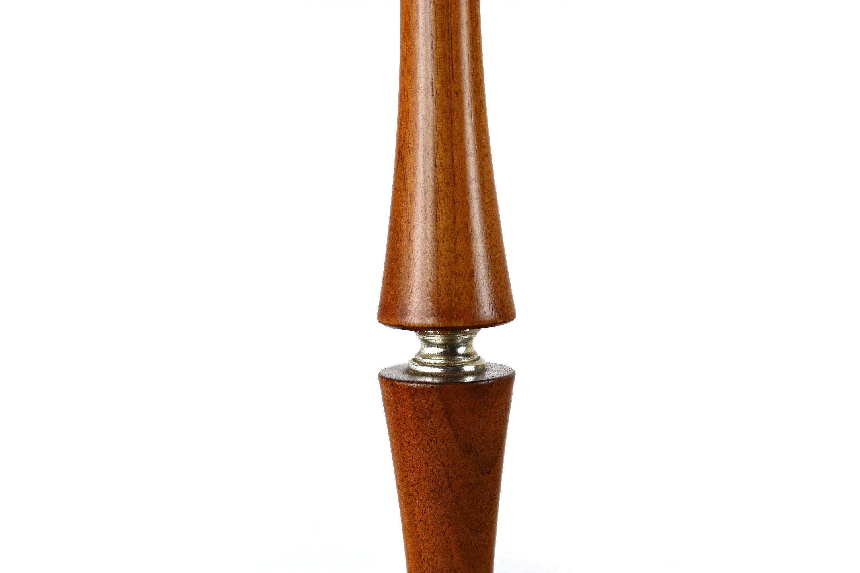 As stylish as it is functional this extraordinary table lamp is in 100% original, vintage condition and aged to perfection. With a visually captivating base constructed of solid teak and a splendid double banding of teak on the light shade all