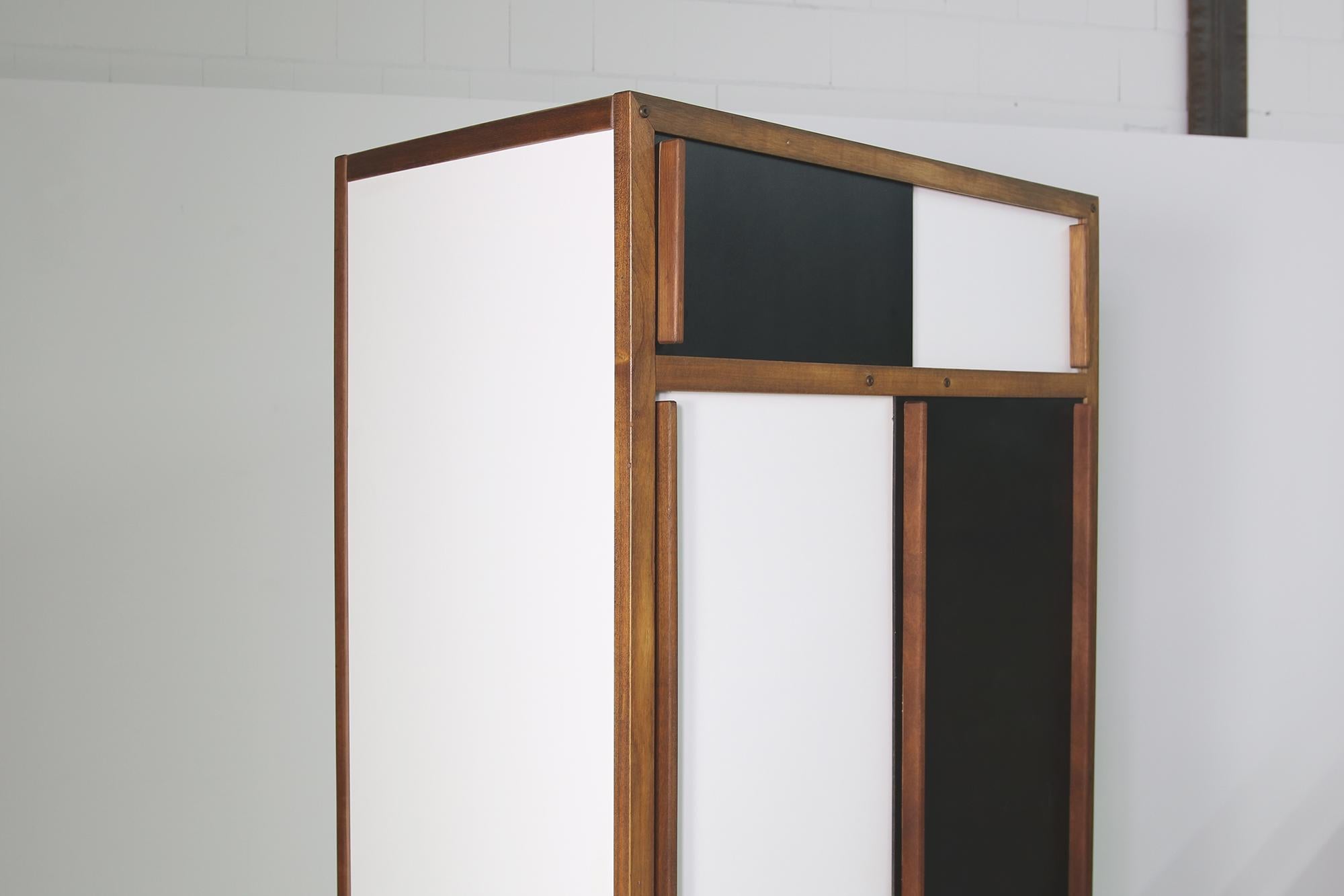 Fantastic vintage cabinet, Andre Sornay, France 1950s, patina, signs of use, was restored a few years ago, solid teak handles, sliding doors, black and white black metal base, the large doors don't close always perfectly, dry, no smell, clean.