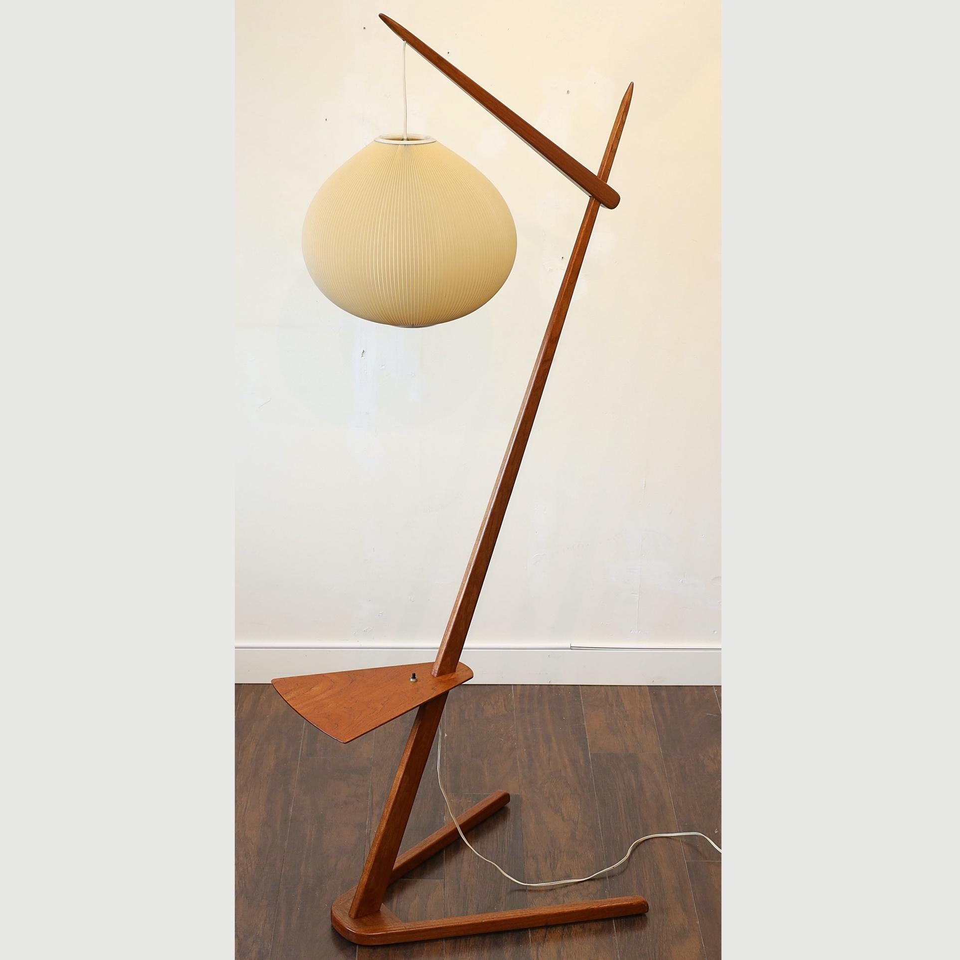 This is a amazing rare floor lamp that gives a large accent to any space with its unique and has a very attractive spherical lamp shade and teak neck structure.

Frame is in Solid Teak and the way the designer put the electric wire is curious enough