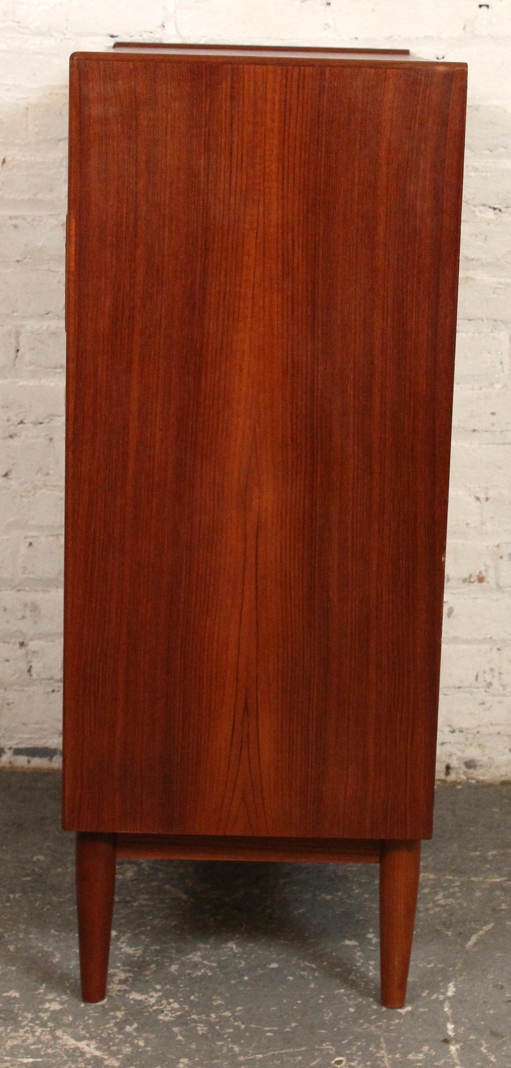A classic example of Scandinavian design, this Mid-Century Modern teak chest of drawers features clean lines, quality craftsmanship, and functional elegance. Crafted in Denmark circa 1960s, the chest offers six spacious drawers with beautifully