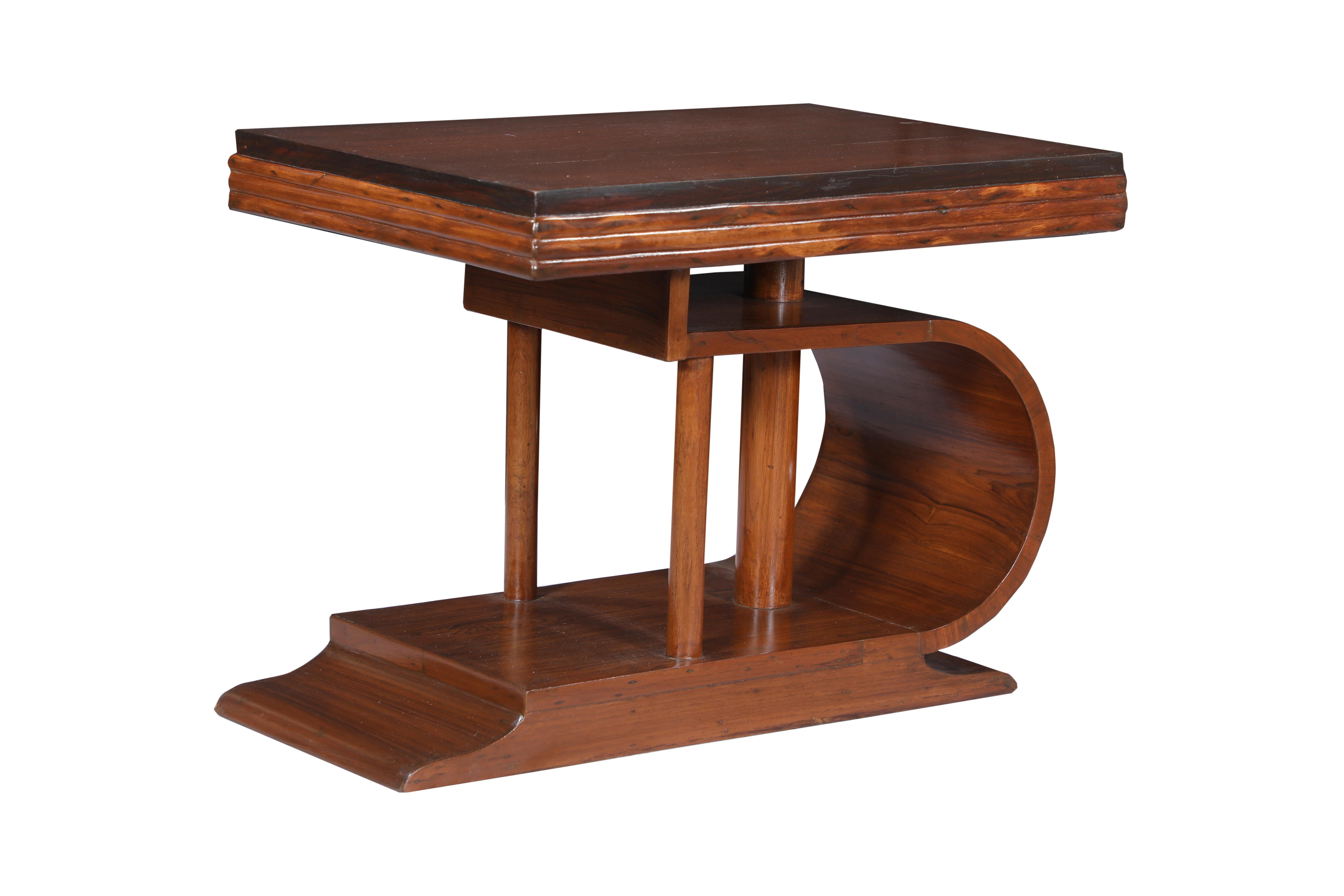 A Mid-Century Modern teak coffee or cocktail table. An unusual base design with reeded edges along the top. Dates to the 1970's and has been refinished.