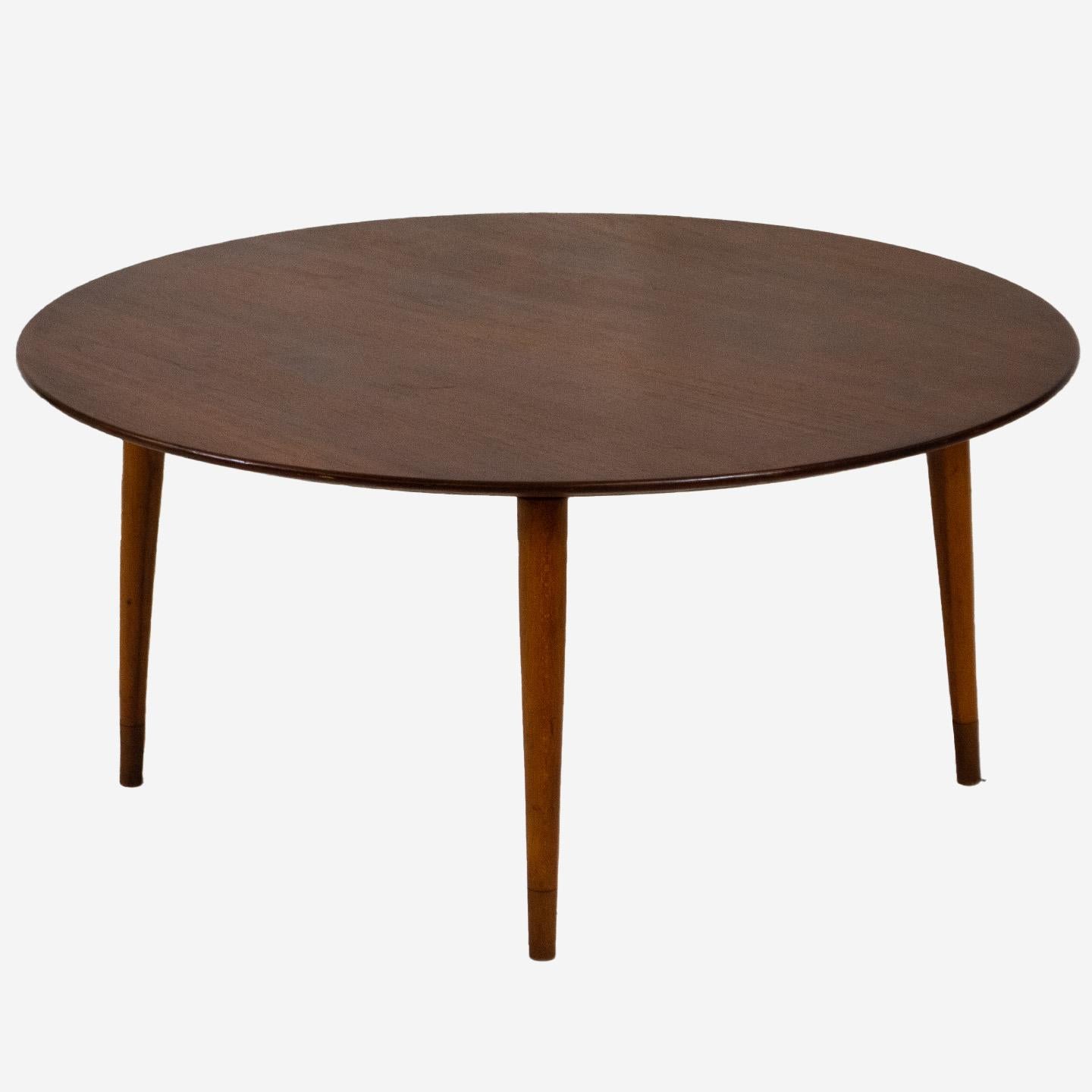 This Mid-Century Modern coffee table is sleek and stylish in design. The teak table top has a beautiful wood grain and constructed with elegant, slender tapered legs. Incredibly understated, yet underside reveals lovely curved joinery and details.