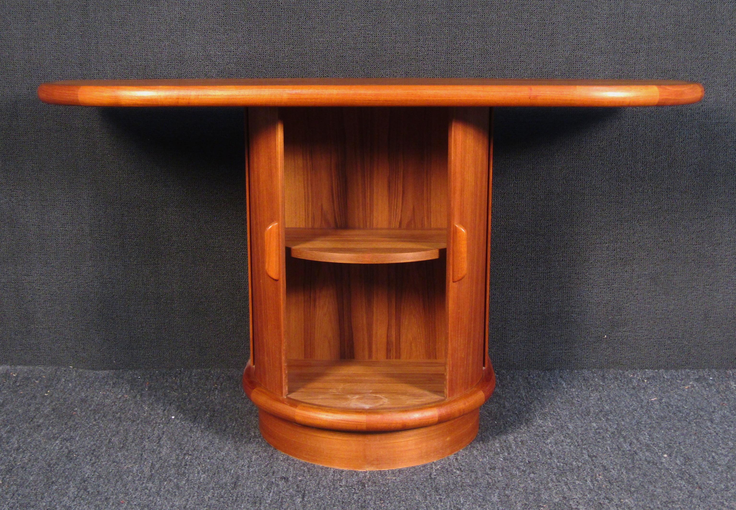 Stunning vintage modern teakwood console table with rounded edges. This table features two curved sliding pocket doors. Quality craftsmanship with elegant teak wood grain throughout that looks great behind the sofa or in the hallway.

Please