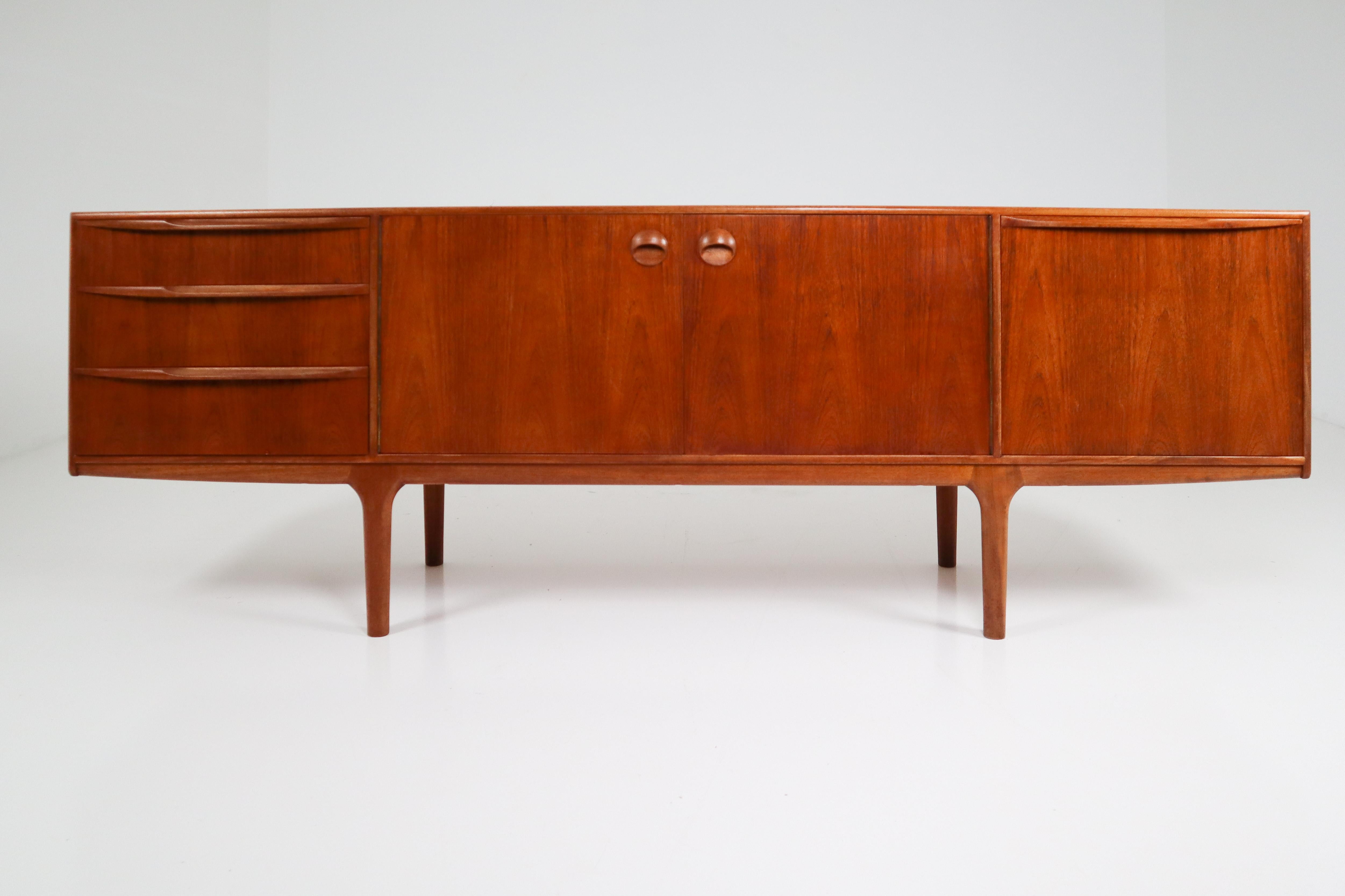 This beautiful vintage modern sideboard features plenty of room for storage within its four drawers and two large storage compartments hidden by cabinet doors. Sleek two-tone design with unique carved pulls and tapered legs adding to the allure.