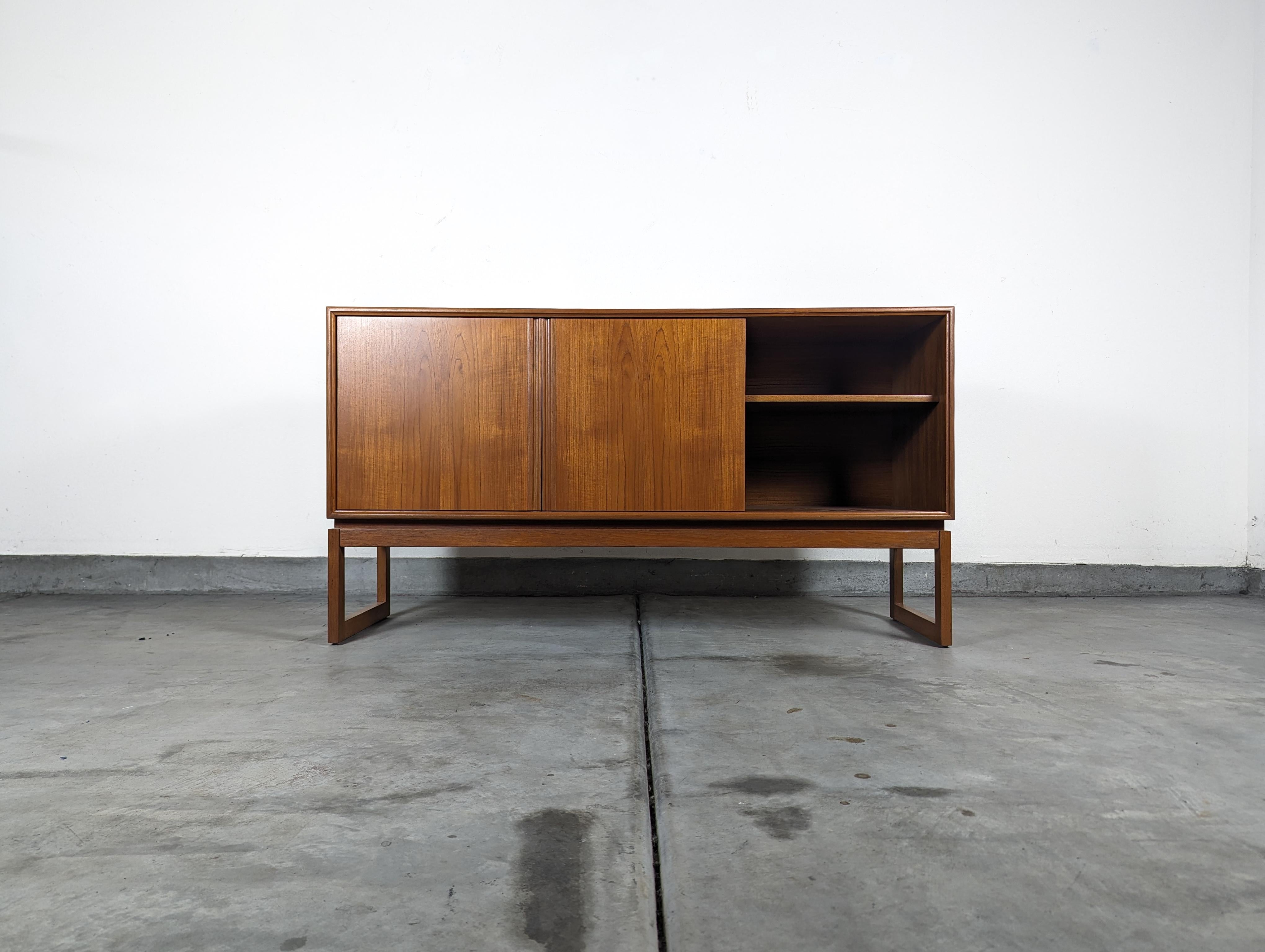 Step back in time and embrace the understated elegance of mid-century design with this exquisite vintage credenza, crafted by the renowned designer Axel Christiansen for ACO Møbler in the swinging 1960s. This timeless piece, measuring approximately