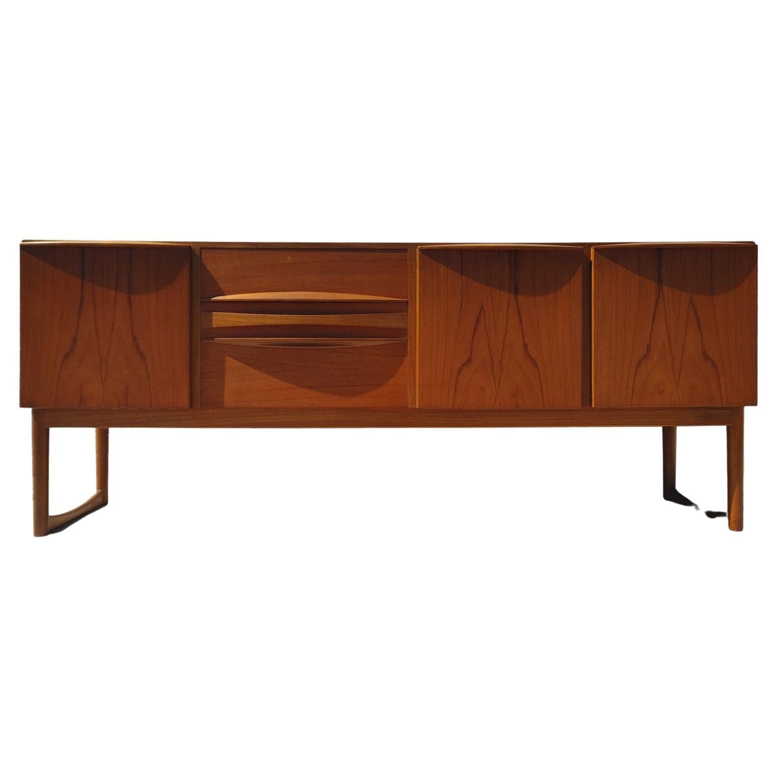 Mid Century Modern Teak Credenza by McIntosh

Above average vintage condition and structurally sound. Has some expected slight finish wear and scratching. Top has been refinished and does not have original factory finish. Outdoor listing pictures