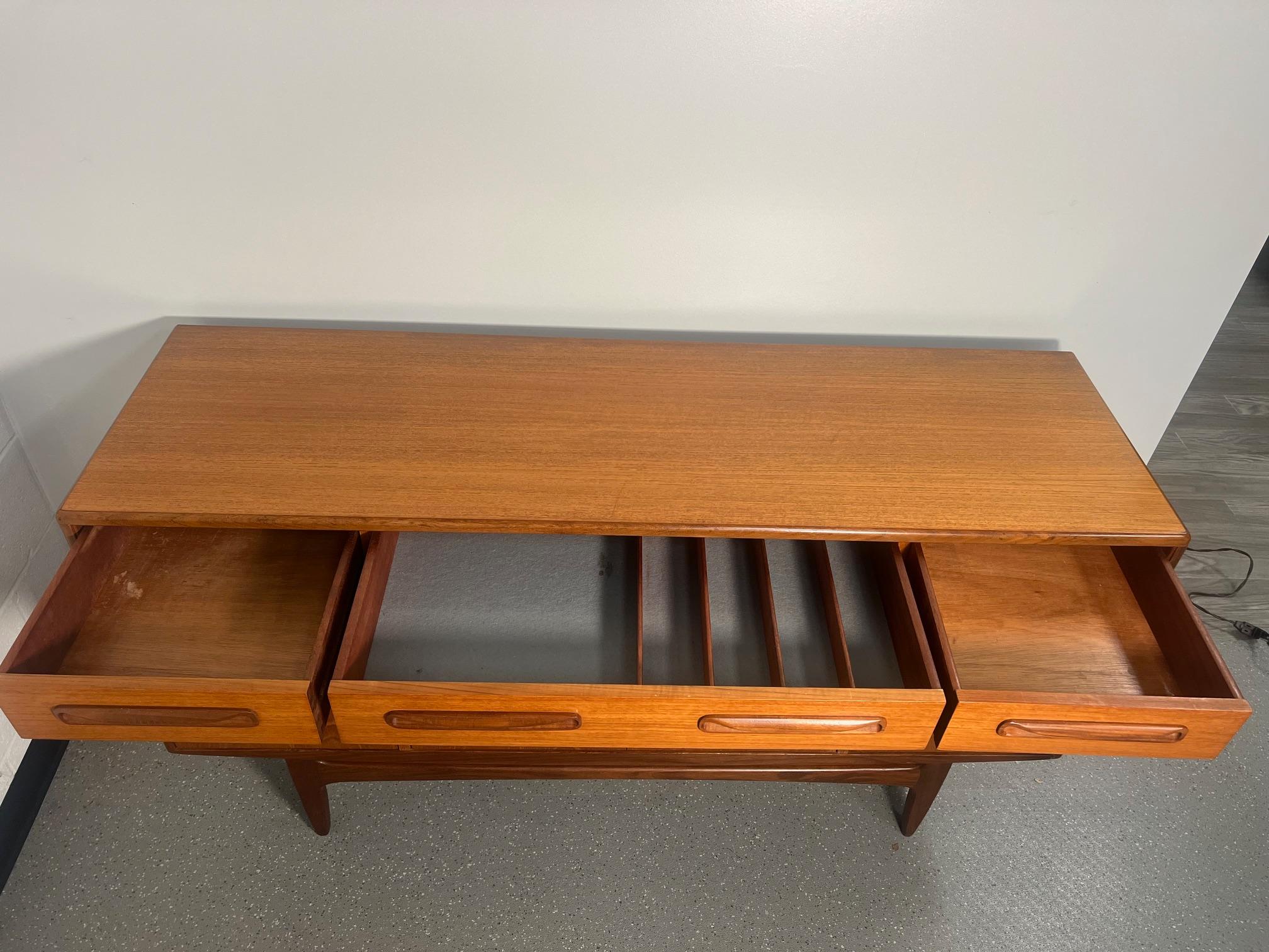 Small teak credenza by G Plan. It was designed in the 1960s by Victor Bramwell Wilkins for G Plan's Fresco Range. It has original grey baize and wood dividers in the top drawer. The wood dividers can be removed. Stain on the fabric inside the