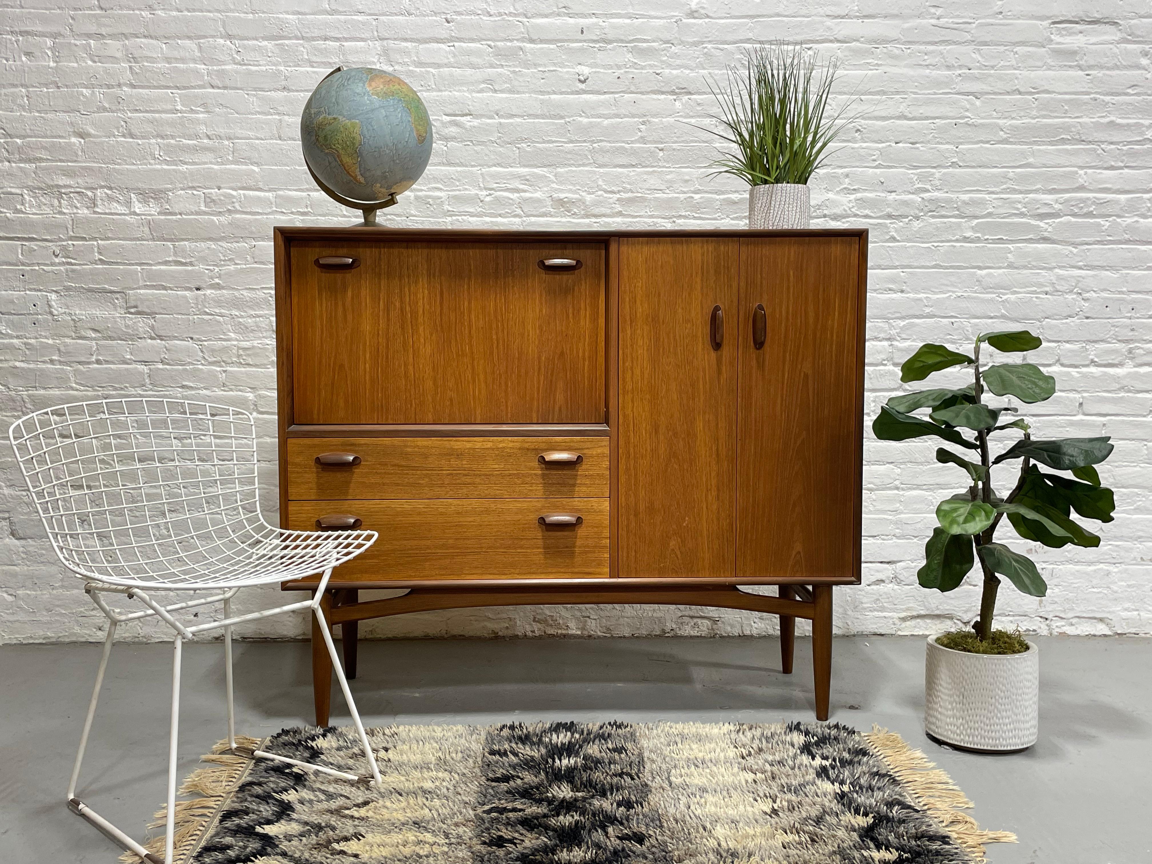 Rare + stunning Mid Century Modern credenza / Highboard by G-Plan, c. 1960s. Perfect as a bar, china cabinet or home office space. Gorgeous in its simple yet extremely functional design. This piece boasts so much  functional storage space....a drop