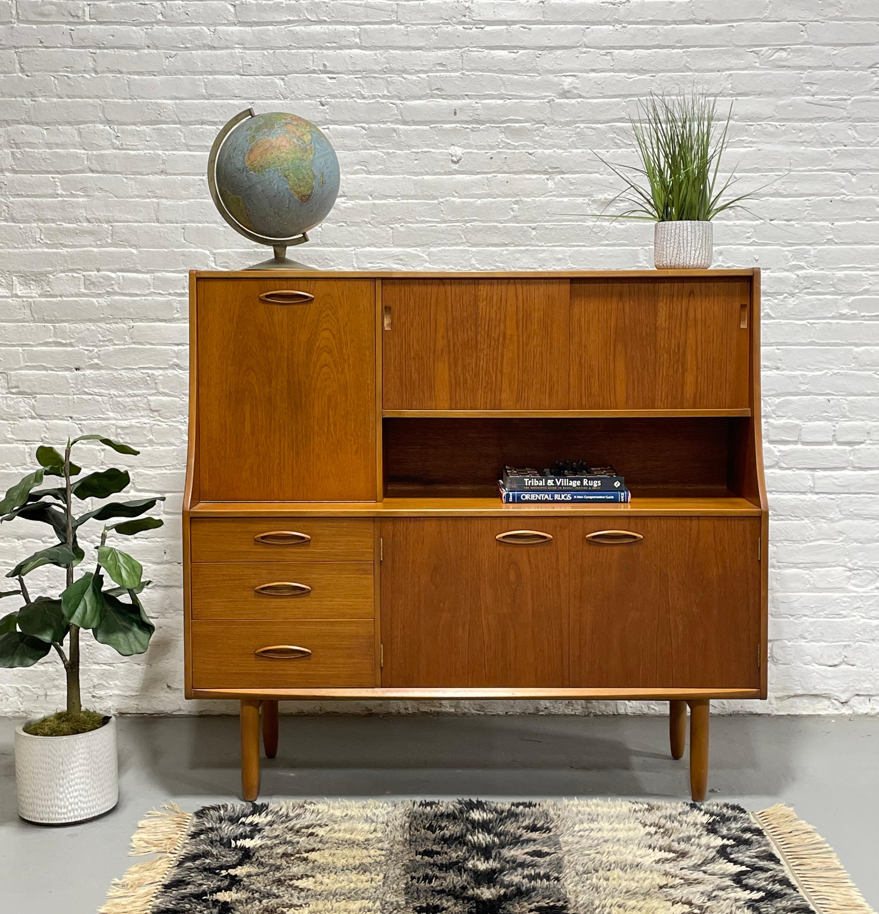 Rare + stunning Mid Century Modern credenza / Highboard by G-Plan, c. 1960s. Perfect as a bar, china cabinet or home office space. Gorgeous in its simple yet extremely functional design. This piece boasts so much  functional storage space....a drop