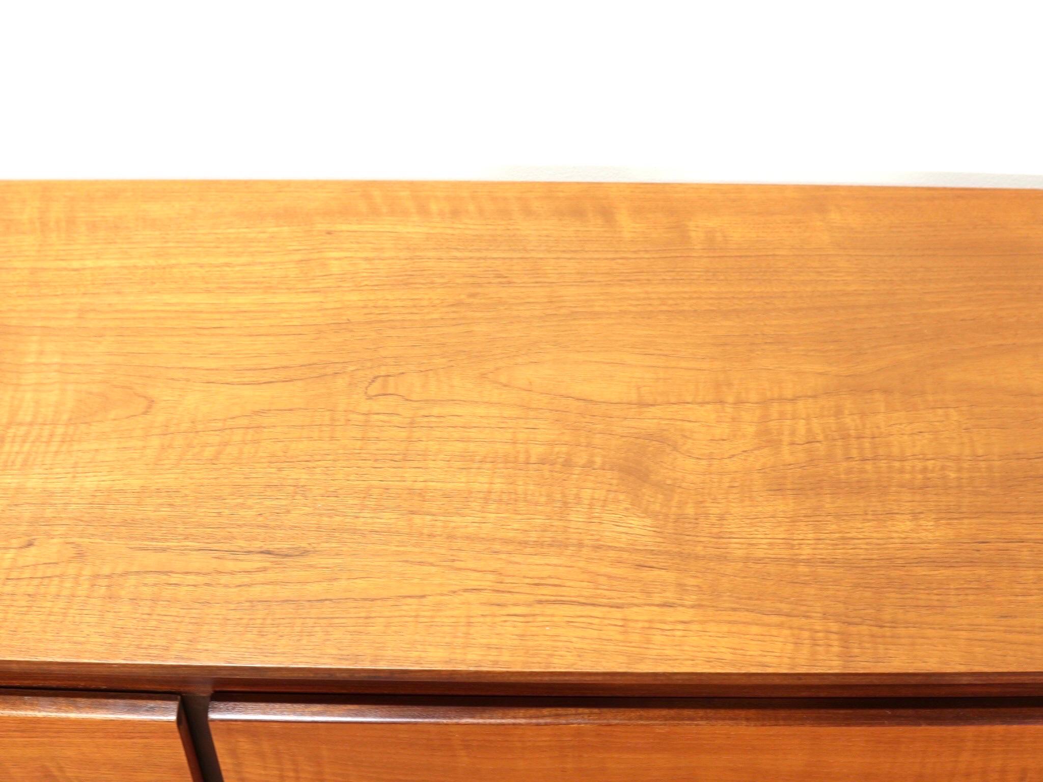 This gorgeous mid century credenza made by Nathan in the 1960's oozes scandinavian style and class with it sleek lines. A special note to the cabinet doors with the pull handles hidden which gives it a striking look.

This crednza would look