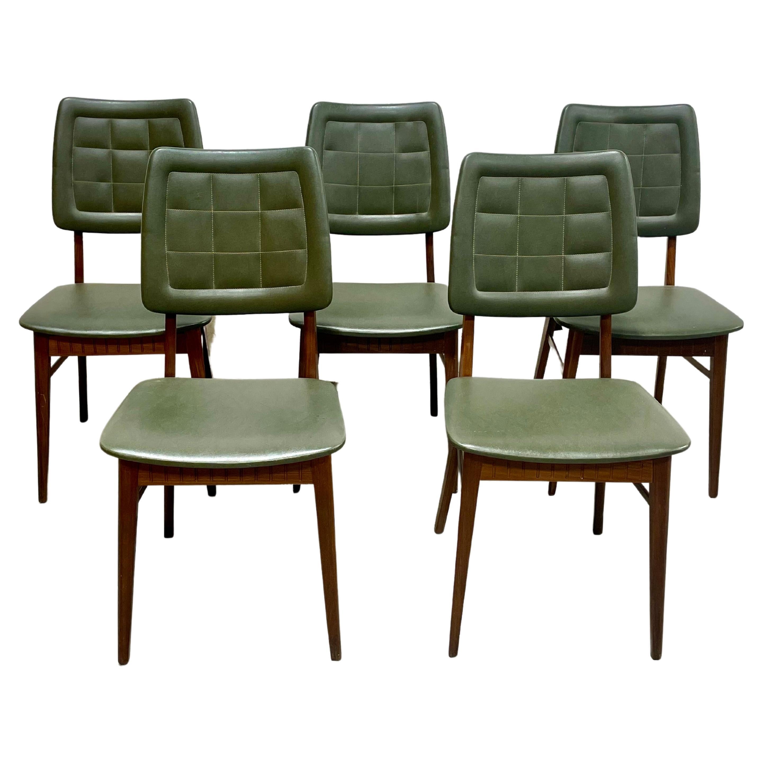 Set of Five Mid Century Modern Teak Danish Dining Chairs, Made in Denmark, c. 1960's.   The stunning teak wood features incredible wood grains and they have all been freshly cleaned and oiled. The chairs are upholstered in hunter green naugahyde and