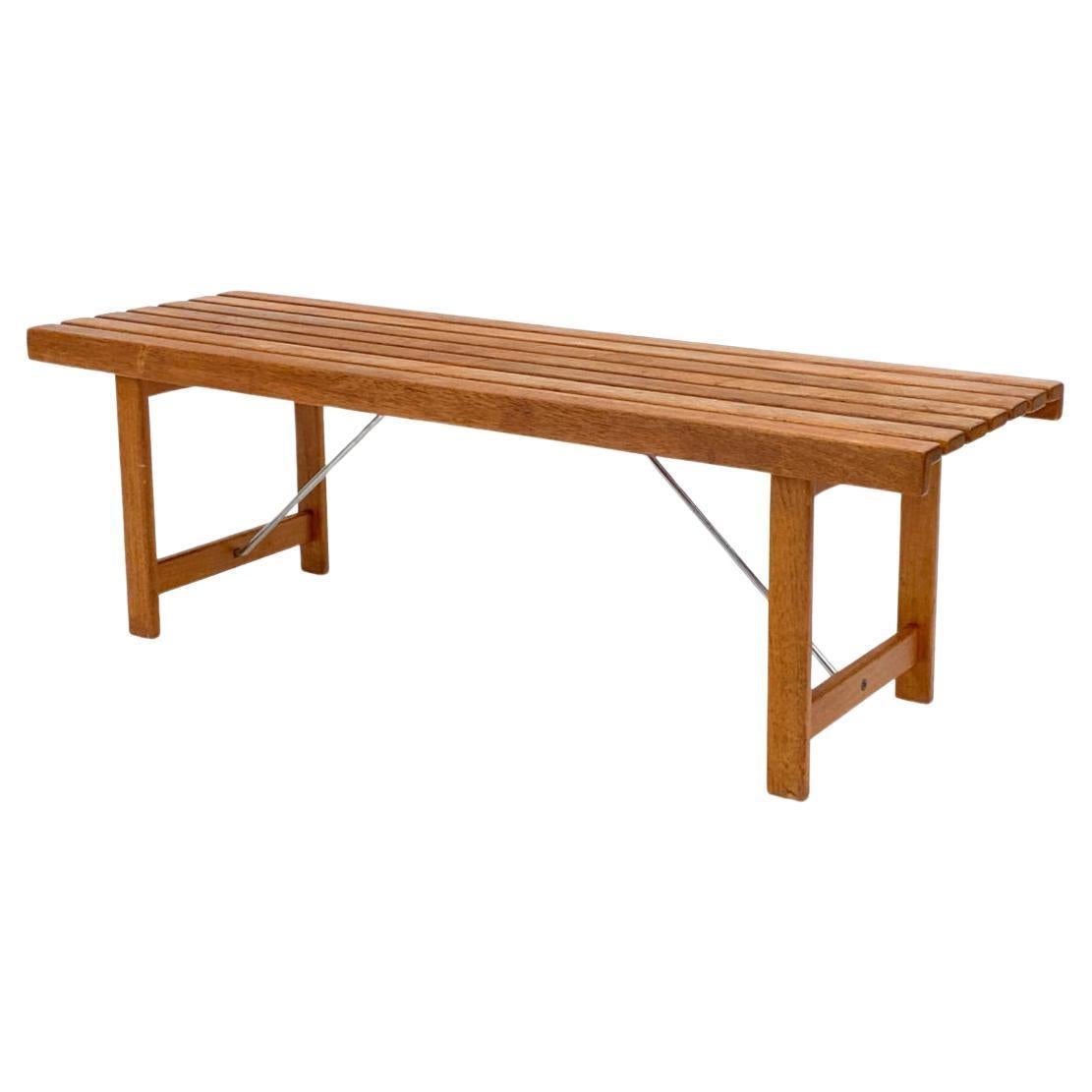 Mid century modern teak danish slat bench with chrome braces. Great simple designed bench. Shows normal wear frame use. Possibly by Hans Wegner - Andreas Tuck. Made in Denmark. Located in Brooklyn NYC.

Measures 50” x 16” x 16” high