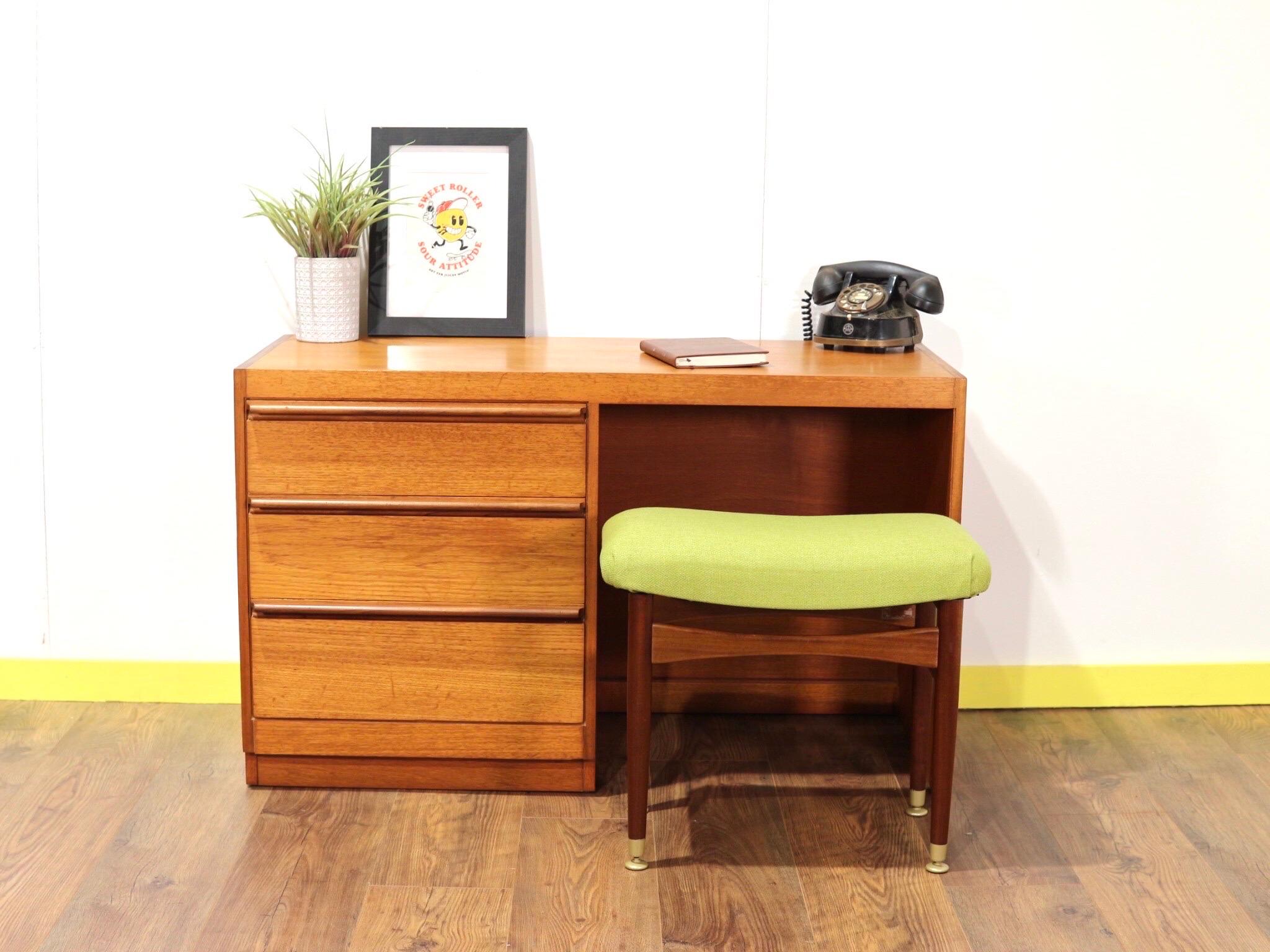 A beautiful compact mid century desk designed by Beithcraft of Scotland with accompanying stool by Nathan. Perfect for the bedroom or office with flanking drawers of a good size. The desk is compact enough to fit in to most