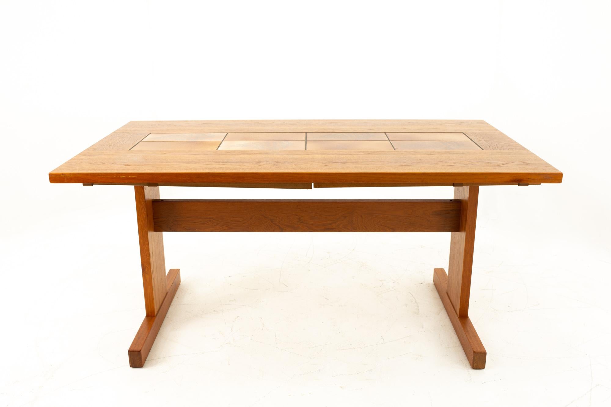 Mid-Century Modern teak dining table with tile inlay

Table without leaves measures: 60 wide x 35.5 deep x 29 high; Table with leaves measures: 90 wide 

This piece is available in what we call Restored Vintage Condition. Upon purchase it is