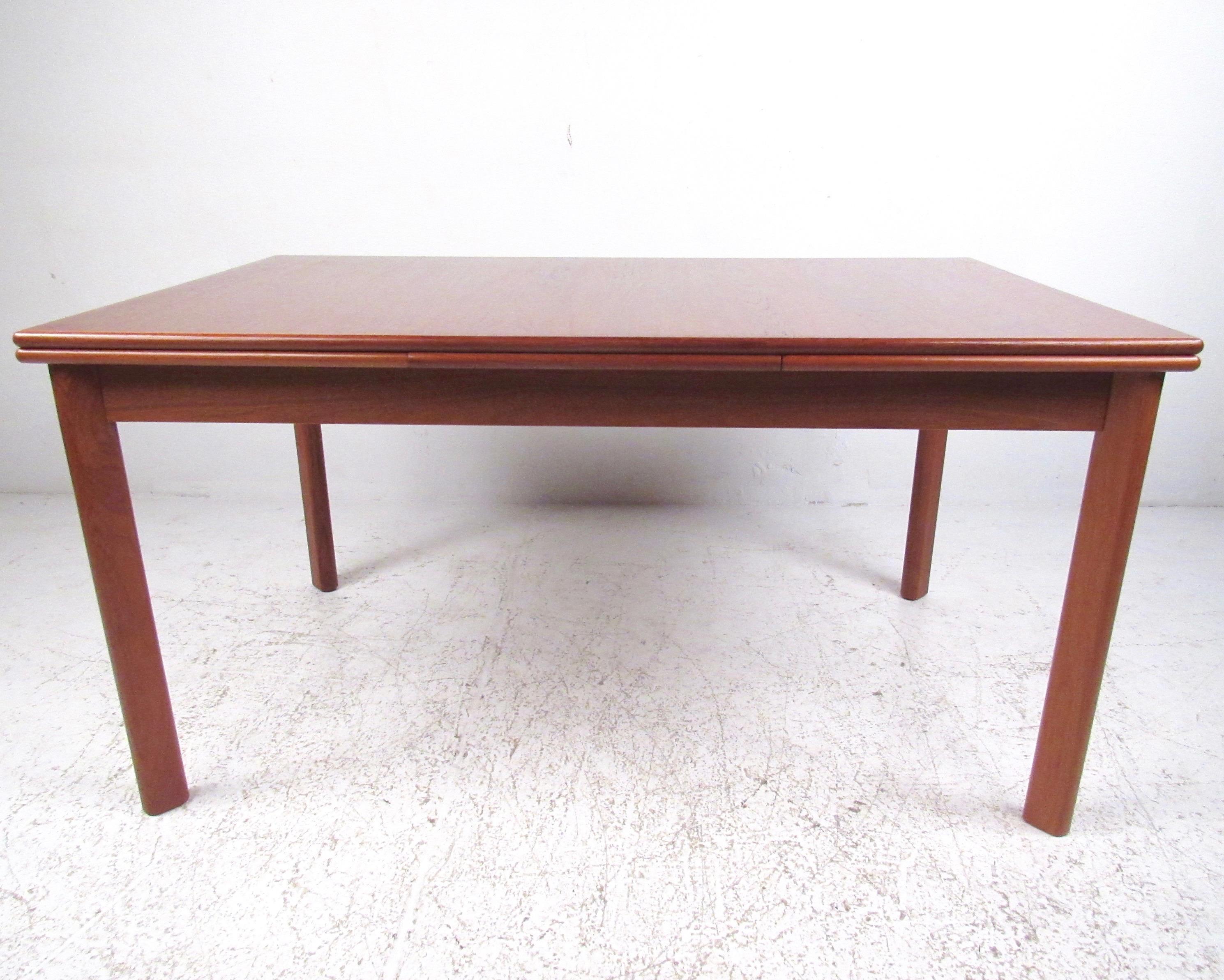This Scandinavian Modern dining room table features pull-out draw leaves with vintage teak construction. Quality Mid-Century Modern manufacturing by Brdr. Furbo of Denmark, this striking vintage modern dining table makes a beautiful addition to a