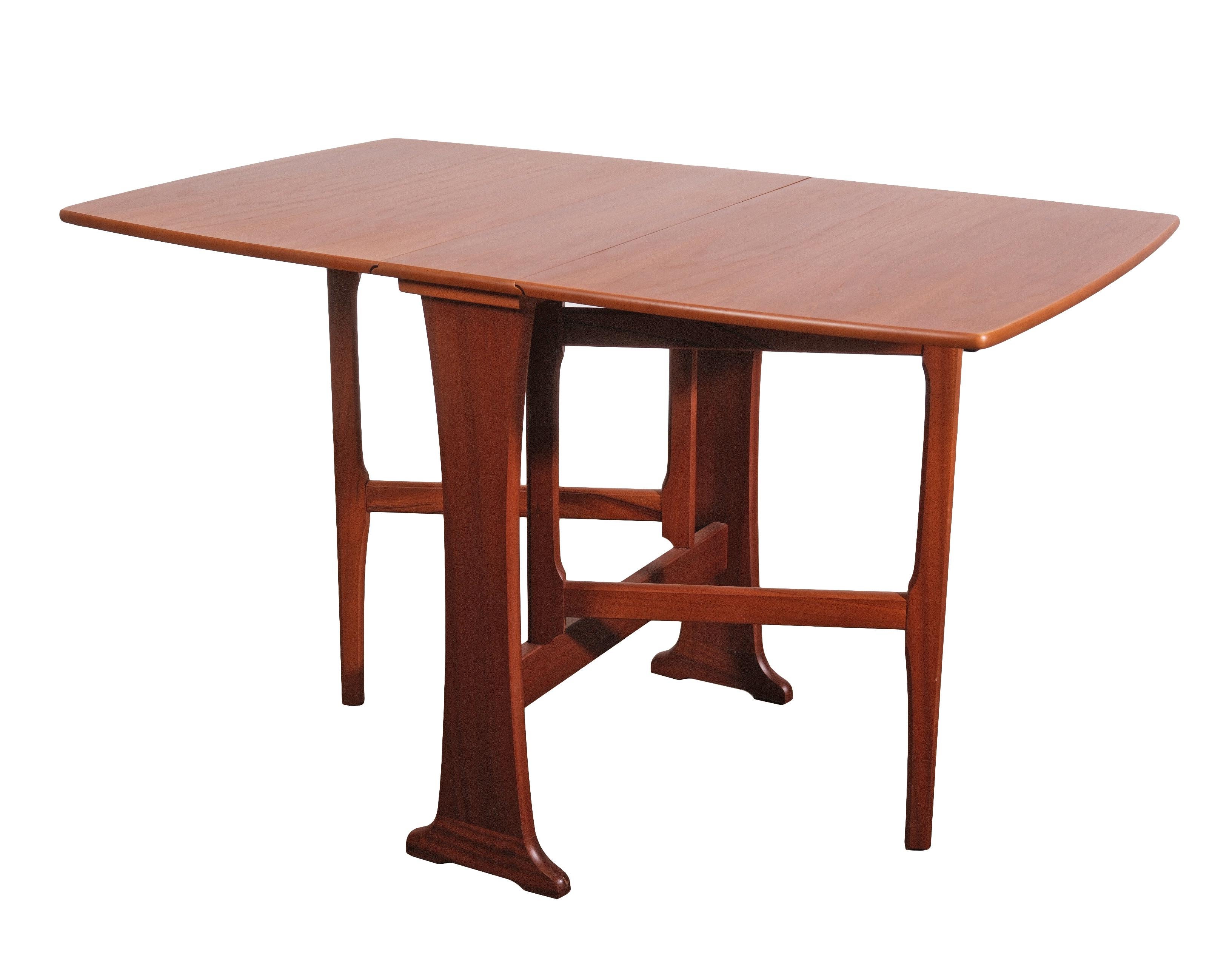 This exceptional Mid-Century Modern Teak Drop-Leaf Dining Table, designed in the distinguished G-Plan 