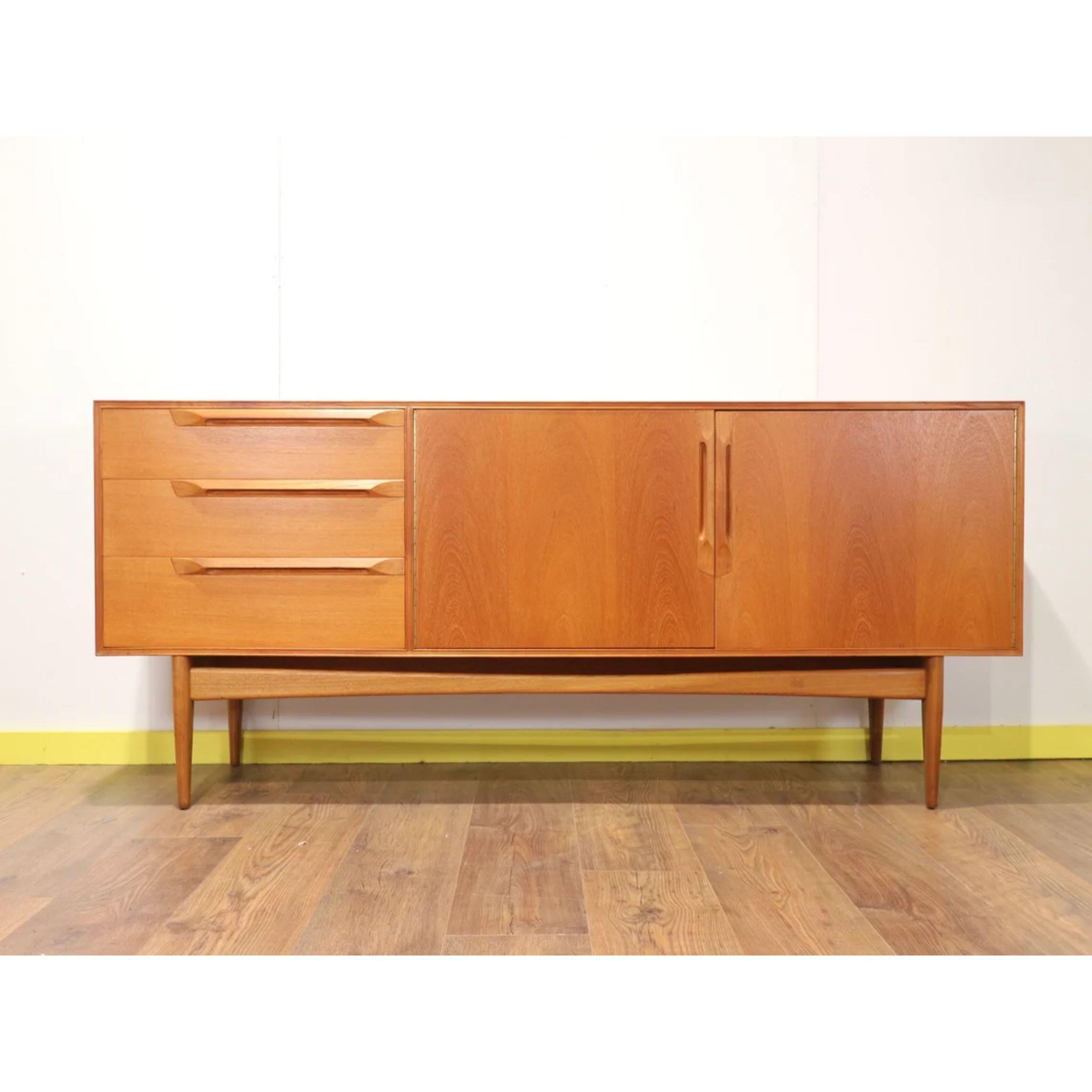 This rare model McIntosh Eden sideboard is a truly outstanding example of mid century design – elegant and beautiful. The bank of 3 drawers to left of this piece include a top drawer lined in black felt with cutlery dividers in place. The sleek,