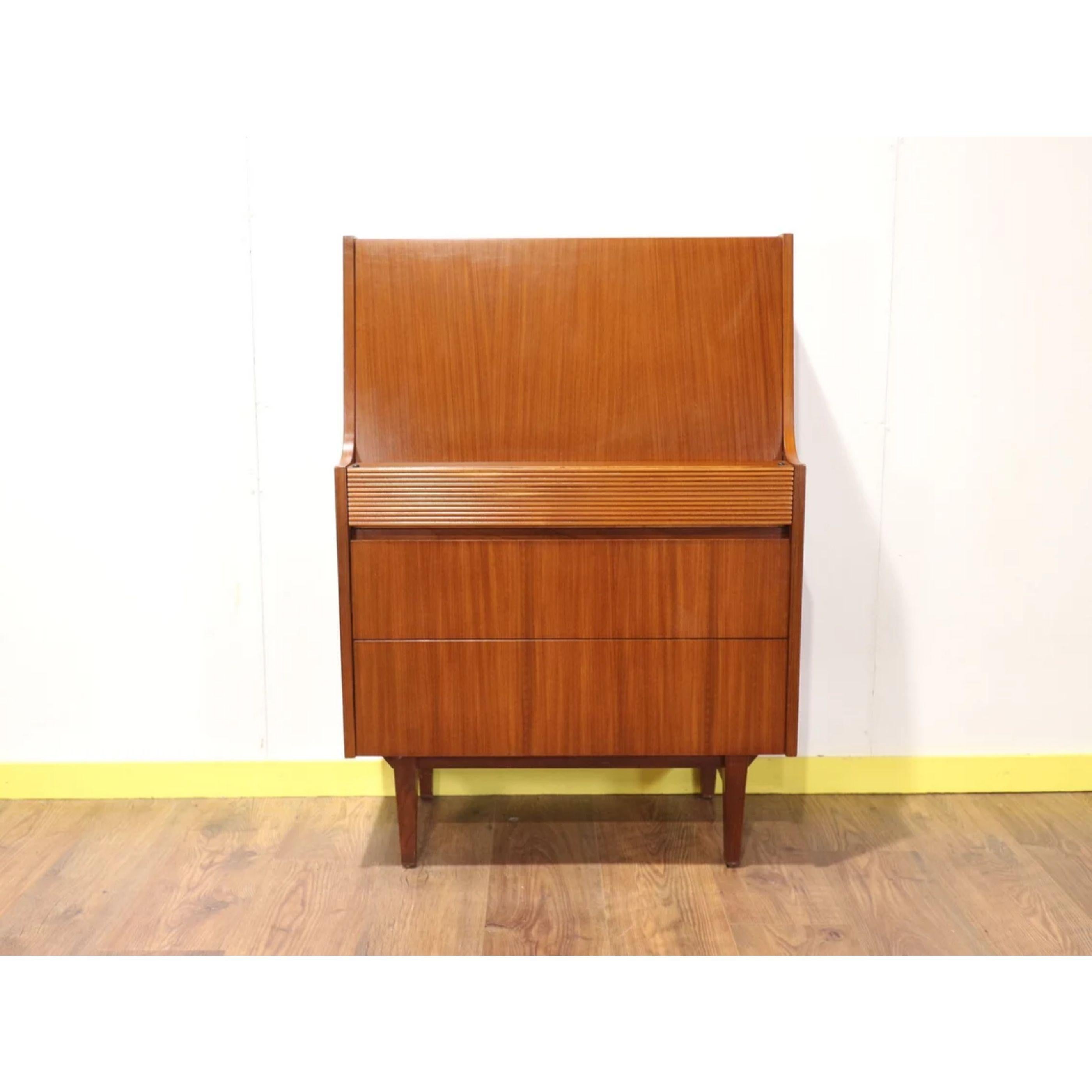 A beautiful Mid century teak bureau by Elliots of Newbury made in the UK, circa 1960s. Great for small spaces and perfect for working on a laptop or as a writing desk. There are 3 drawers all with neatly hidden openings.

Dims
w30 d16