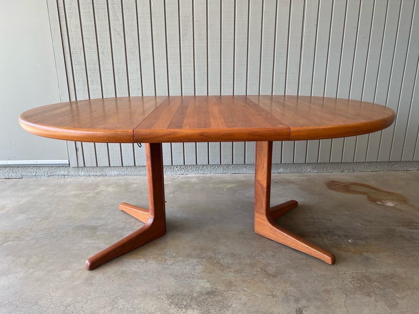 Mid century modern teak extending dining table with two leaves. It is a round pedestal table when no leaves are used. Danish, 1960s-70s, no maker’s mark but purchased from original owners that had it paired with Moller chairs. In excellent condition