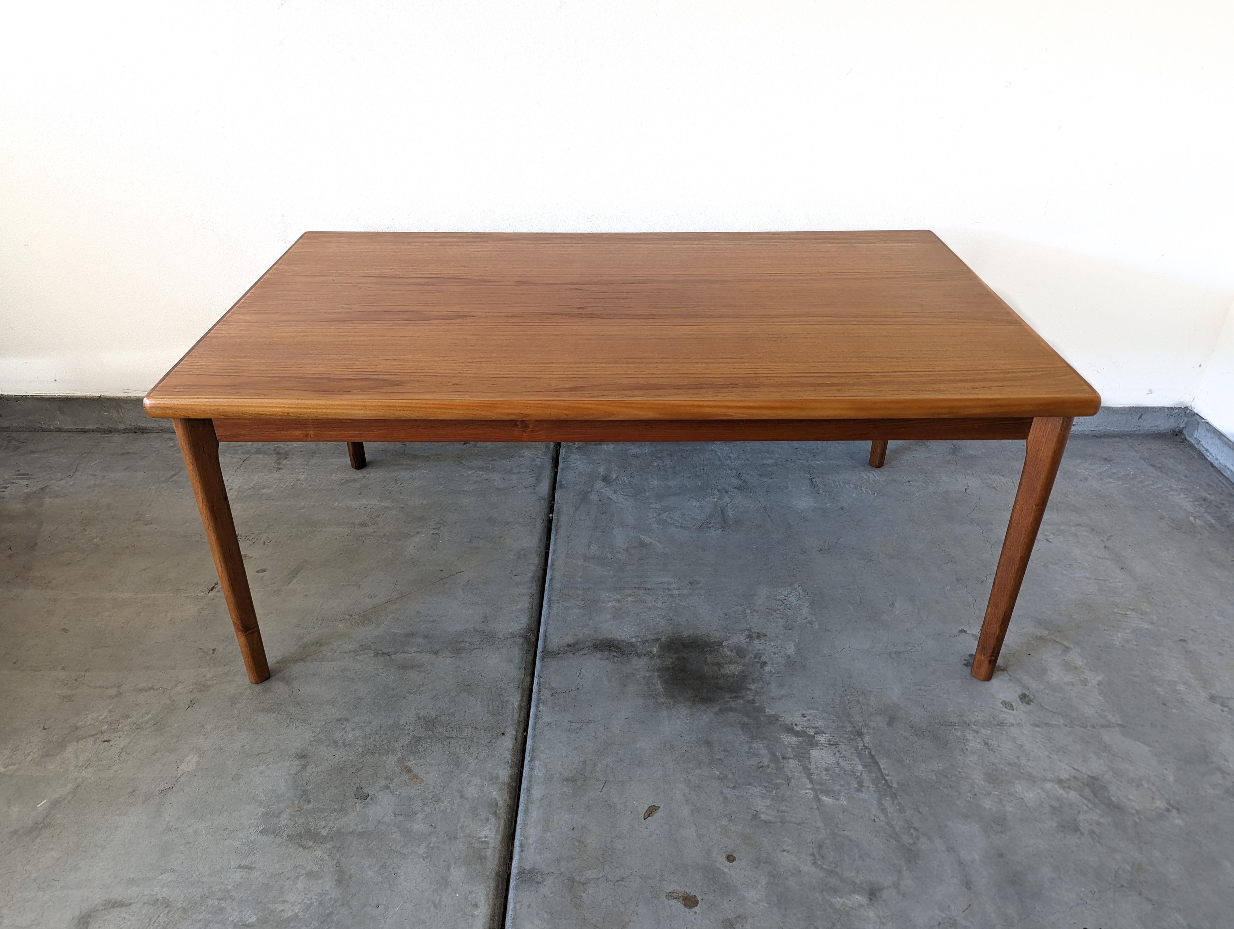 For sale is a stunning vintage mid-century modern Danish teak dining table, masterfully crafted by Gudme Møbelfabrik in the 1960s. This statement piece, with its timeless aesthetic and Danish design pedigree, is sure to be the focal point of your