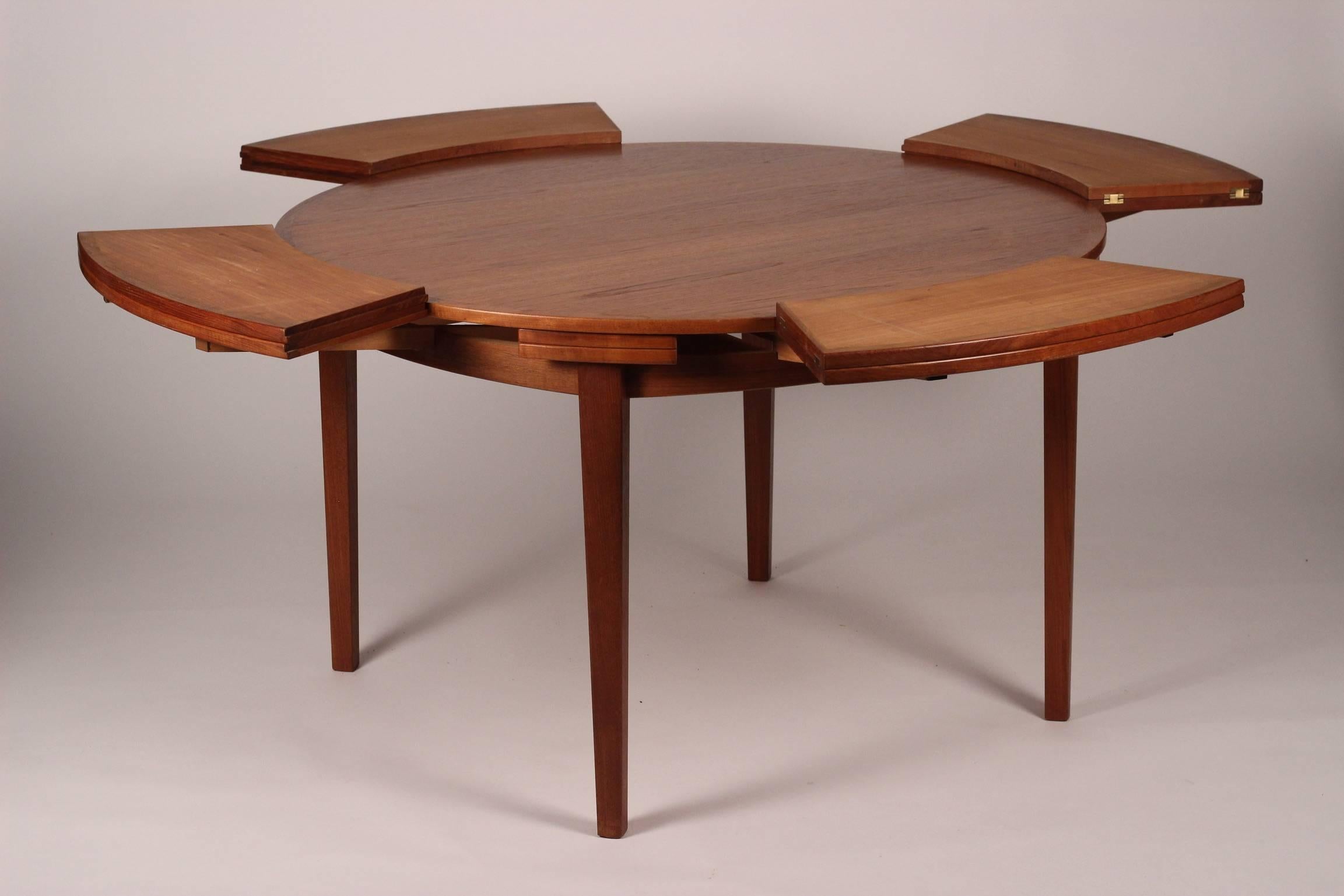 Ingeniously designed by Dyrlund this teak flip flap table or lotus table in teak opens out from a table that comfortably seats four and can then enlarge via hidden flaps to open out to 174cm and seat between 6-8.
Professionally restored and