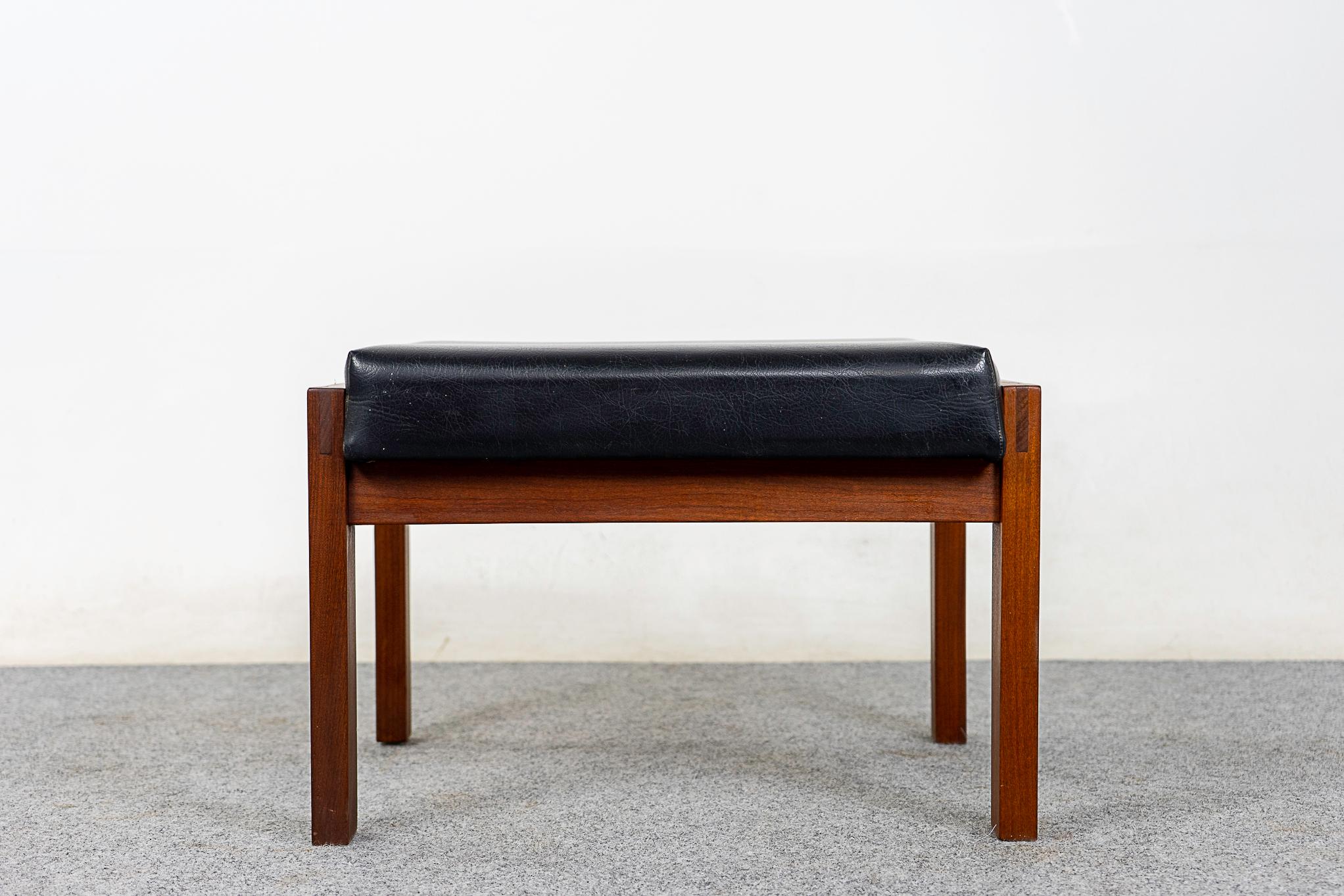 Teak Danish footstool, circa 1960's. Robust frame with unique joinery and lovely deep tone contrasts nicely with the original upholstery in nice condition.