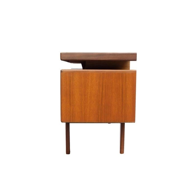 Mid-Century Modern G-Plan 'Fresco' desk/dressing table, English, ca. 1960. 
Featuring a floating top, contrasting afrormosia wood detailing, two drawers to each side, on solid teak legs.
British furniture designer Victor Bramwell (V.B.) Wilkins is