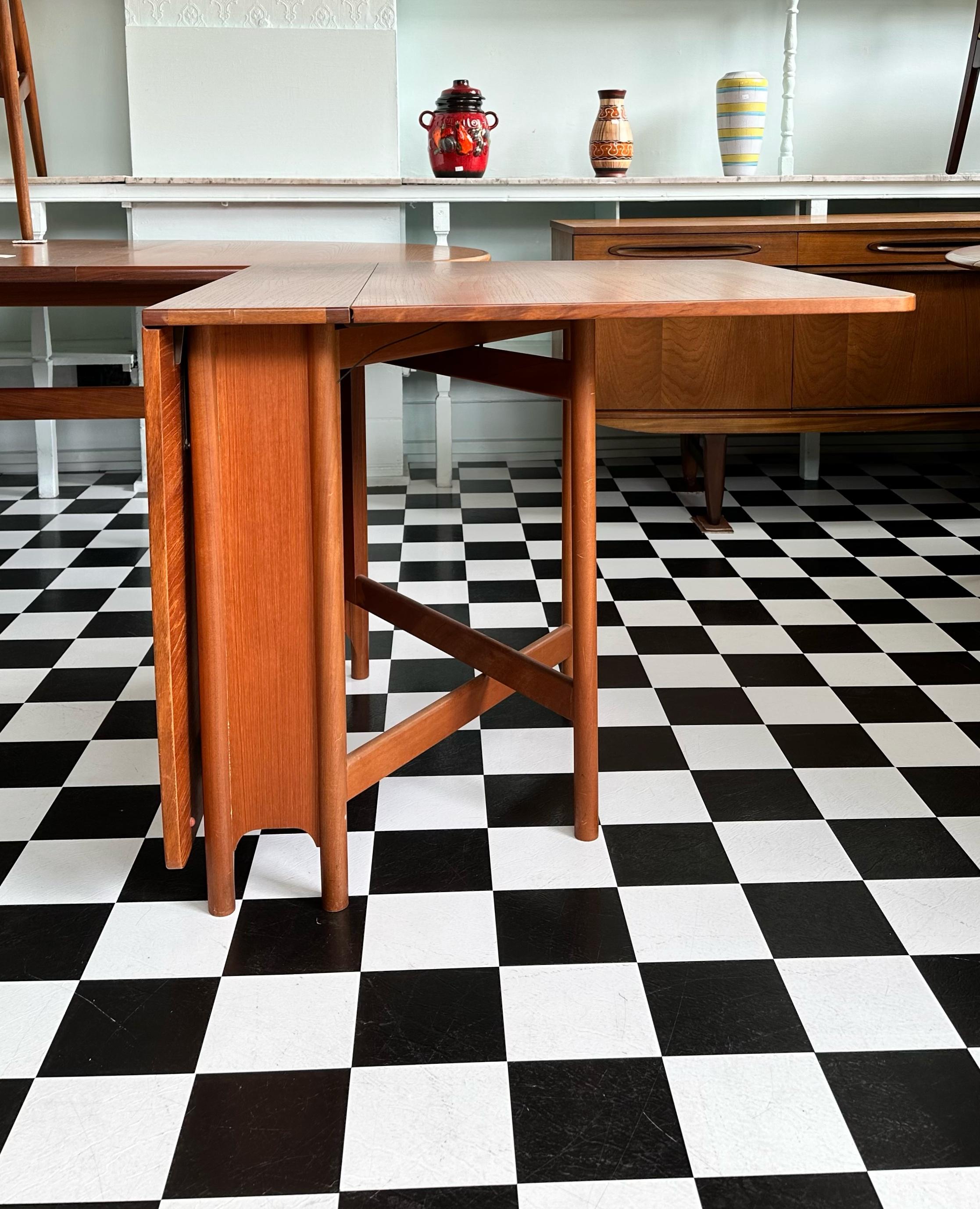 Beautiful mid-century teak double gated table. Designed by A.H. McIntosh of Kirkcaldy, Scotland circa 1960s. This table can fold to be compact or open to seat up to six. Very versatile. Skilfully made using high quality materials. Very stylish