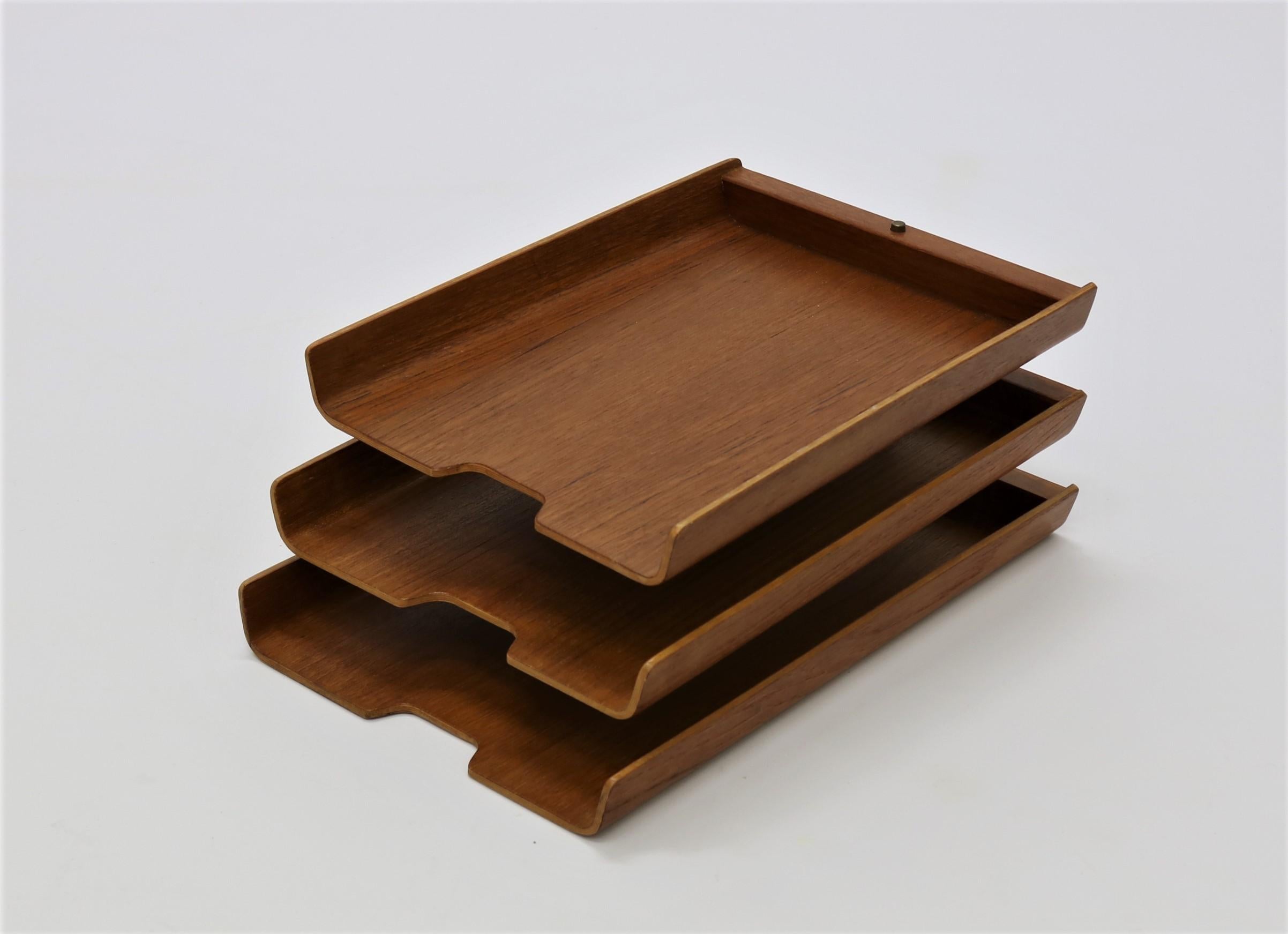 Rare triple letter tray by Martin Aberg for Servex of Sweden, circa 1960. The trays are made of molded teak plywood and are mounted on brass fittings. The trays can be adjusted in any number of configurations.