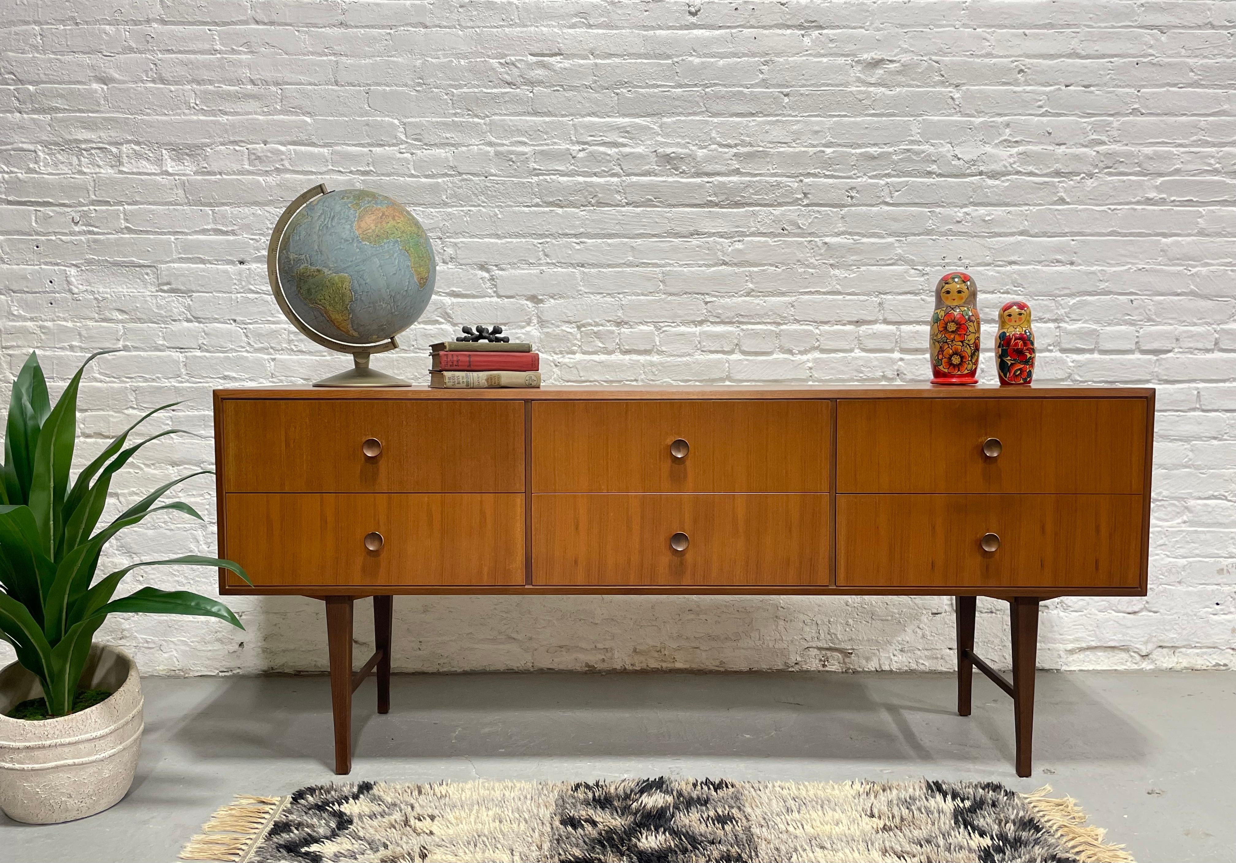 Mid Century Modern Teak Long Dresser / Sideboard, Made in Denmark, c. 1960's. This lovely teak credenza offers six deep and spacious dovetailed drawers - perfect for all your storage needs. Lovely round hand-pulls and long sexy legs give this