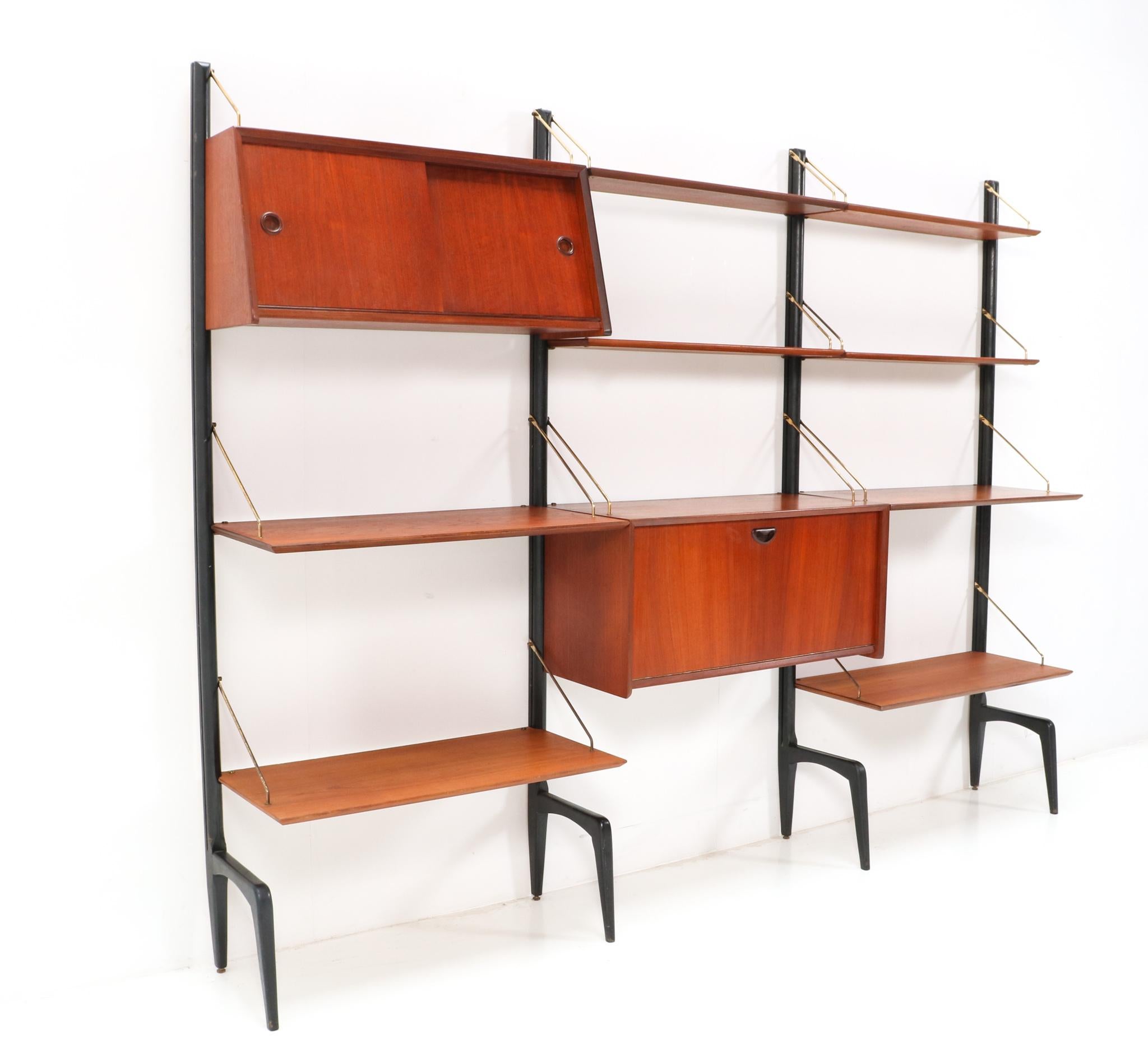 Stunning and rare Mid-Century Modern free standing modular wall unit.
Design by Louis van Teeffelen for WéBé.
Striking Dutch design from the 1950s.
This modular free standing wall unit consists of:
4 original black lacquered wooden uprights H: