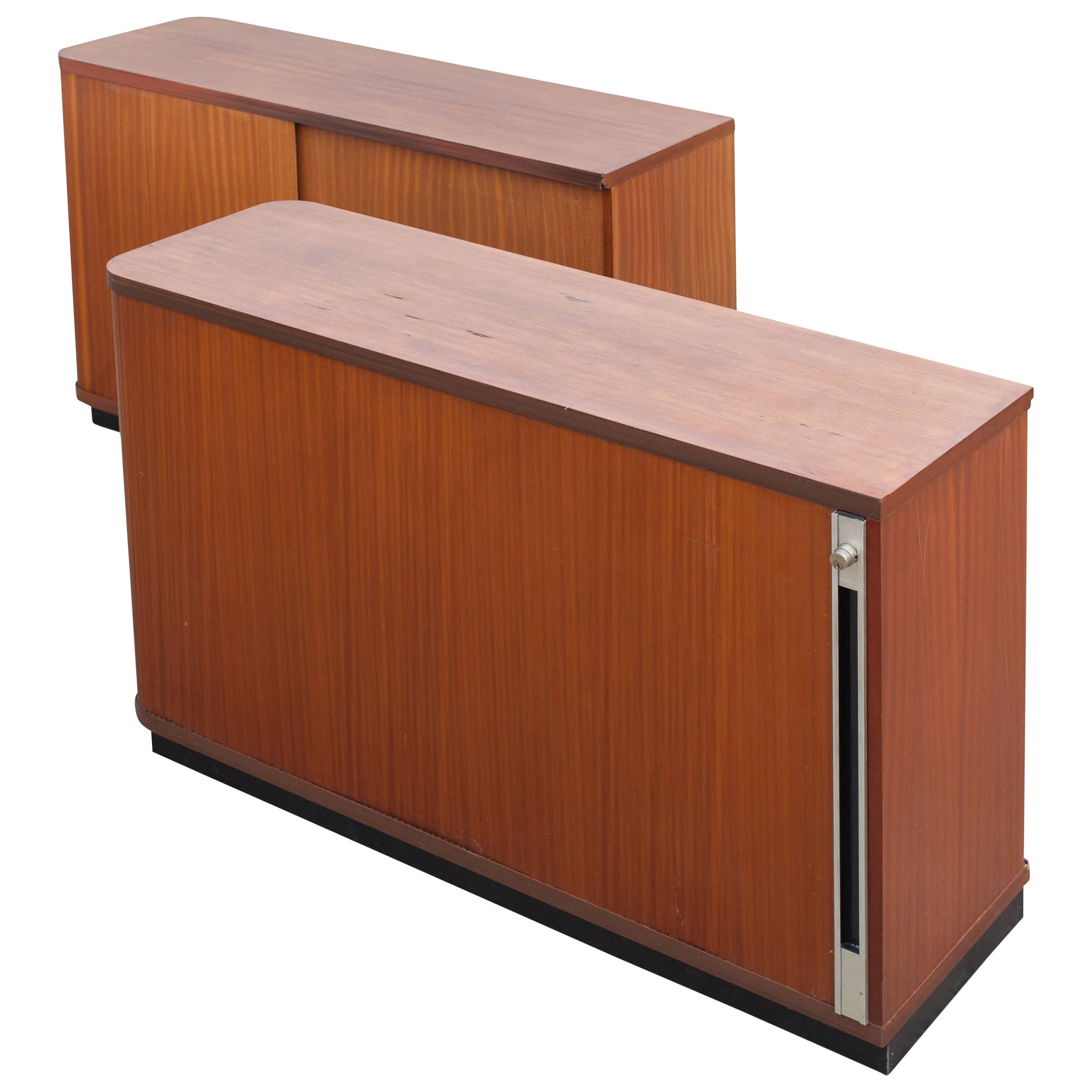 Florence Knoll style set of two teak office sideboards with tambour doors.

Can be used as room dividers since the back are also finished in teak. 
The cabinets are equipped with sliding doors, several shelves, and locks.

Measures: W 125, D