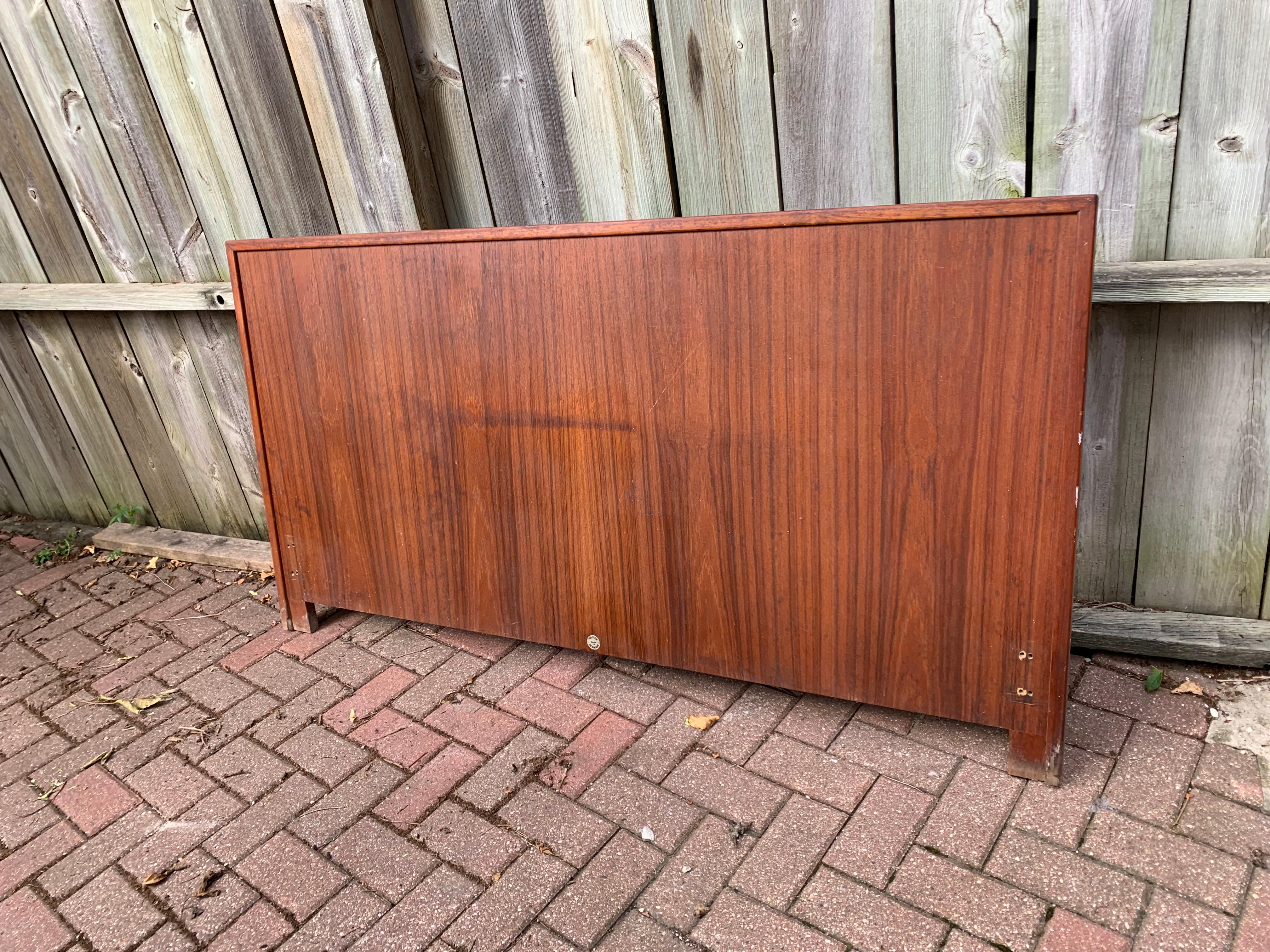 Dramatic placement of the teak grain defines the beauty of this simple but impressive Danish Modern headboard. The wood is unadorned allowing the grain to shine, 
iconic midcentury styling 
part of a set including gentleman's cabinet, dresser and