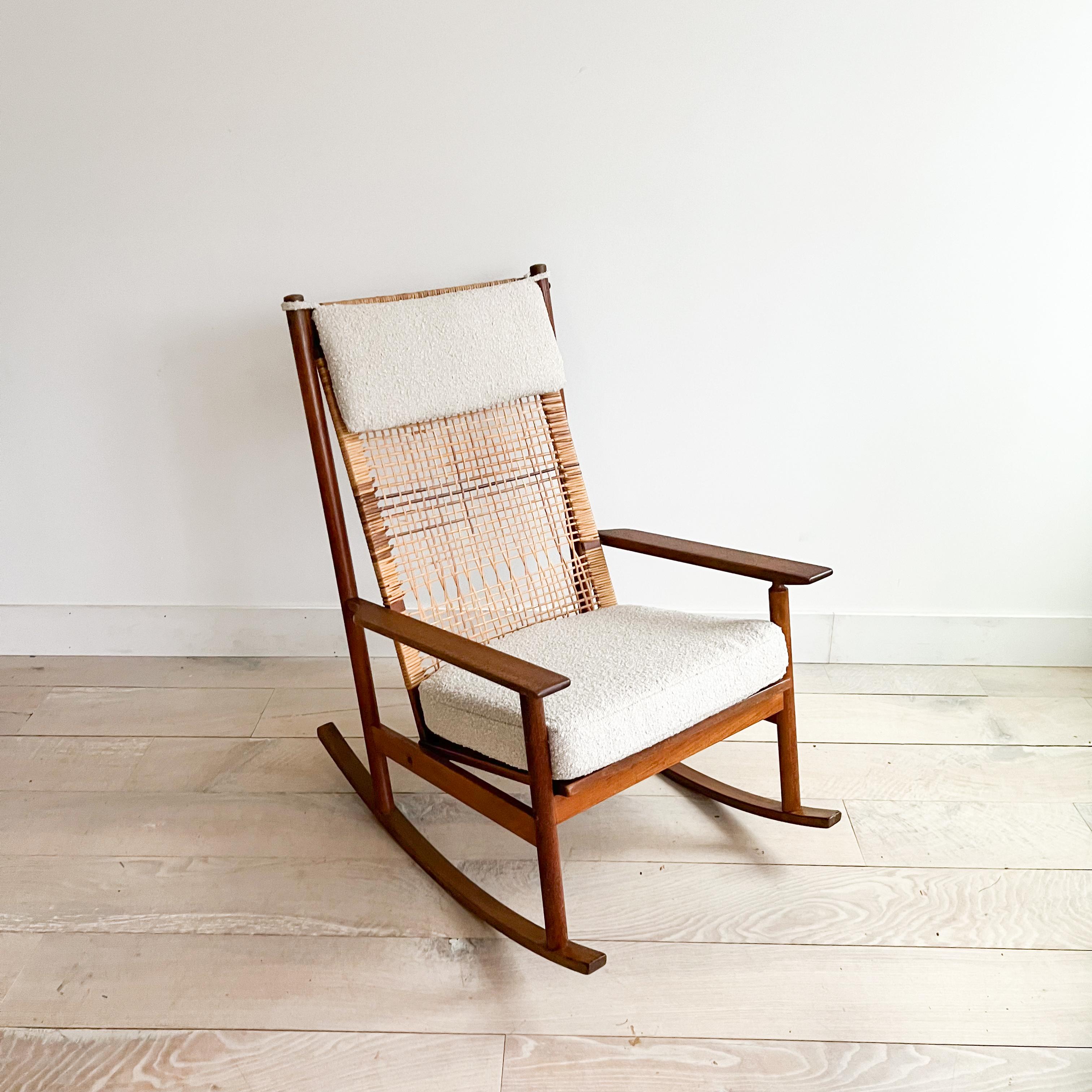 Presenting an exquisite mid-century modern rocking chair designed by the iconic Hans Olsen for Dux. Crafted with precision, this teak and woven cane rocking chair is a testament to timeless design and exceptional craftsmanship.

Stamped for
