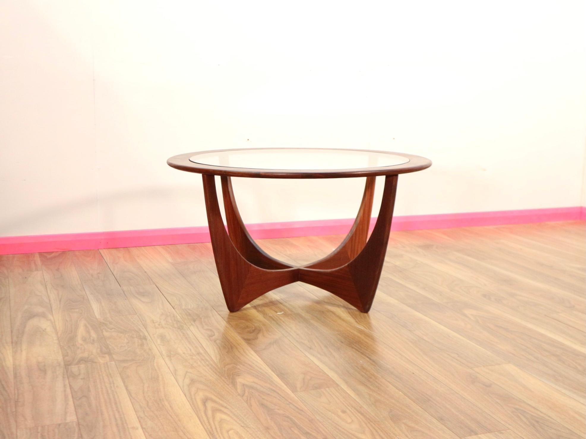 A Midcentury oval Astro teak coffee table with glass top by G-Plan in the 1960s. A uniquely beautiful sculptural coffee table designed by Victor Wilkins and manufactured by Gplan in England, the legs especially scream style.
