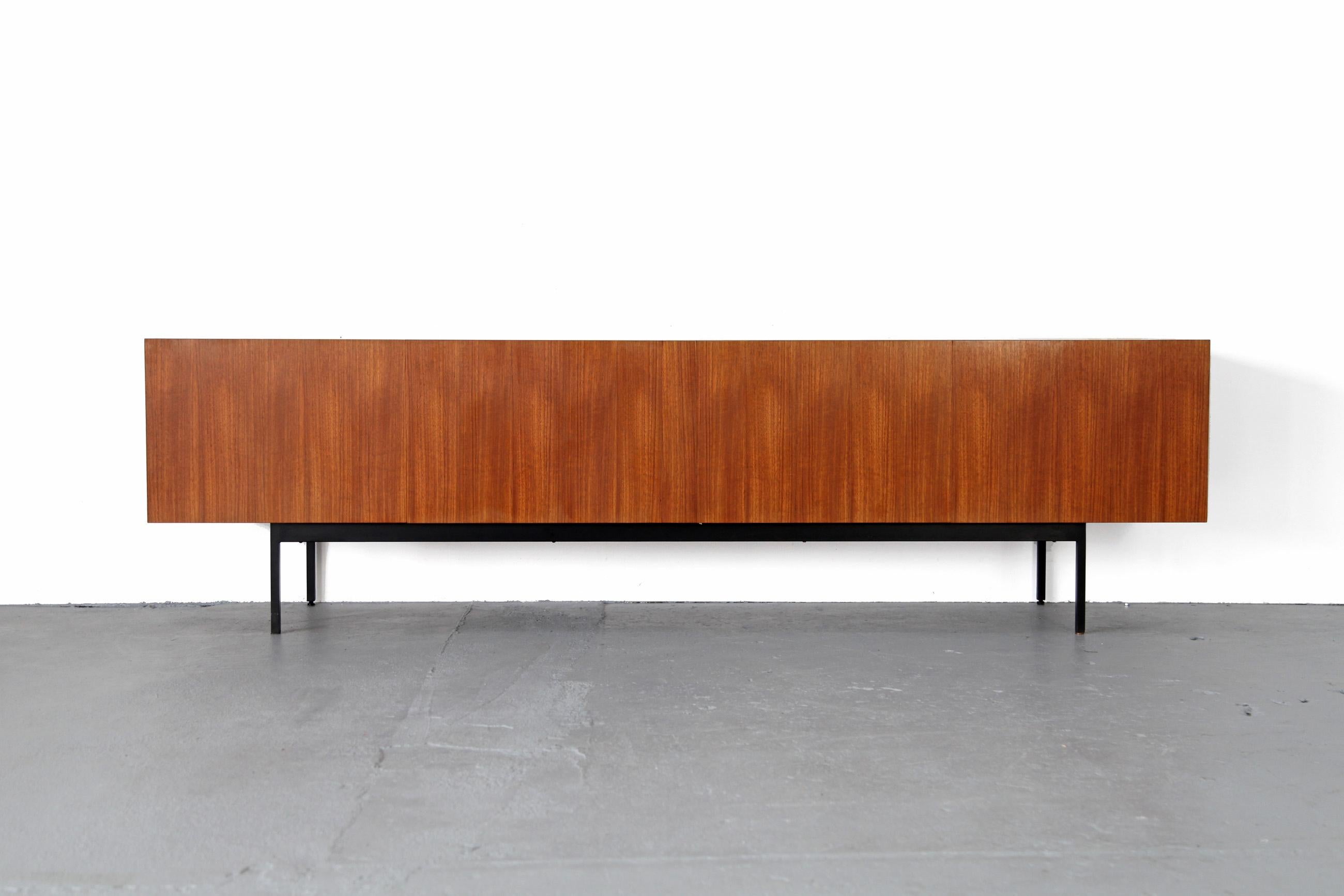 A classic piece of furniture from the late 1950s designed by Dieter Waeckerlin. The sideboard is veneered with teakwood on the outside and maple wood on the inside.