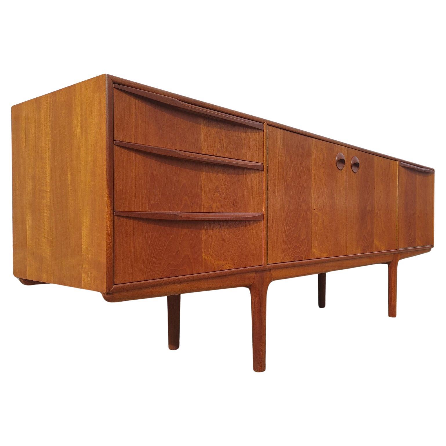 Mid Century Modern Teak Sideboard by McIntosh

Above average vintage condition and structurally sound. Has some expected slight finish wear and scratching. Front edge has a ding and front top has some small discoloration visible in listing pictures.