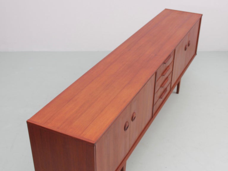 Mid-Century Modern teak sideboard by Rudolf Bernd Glatzel for Fristho Franeker consisting of 4 drawers in the middle and 2 compartments with double doors with 1 loose shelf inside.