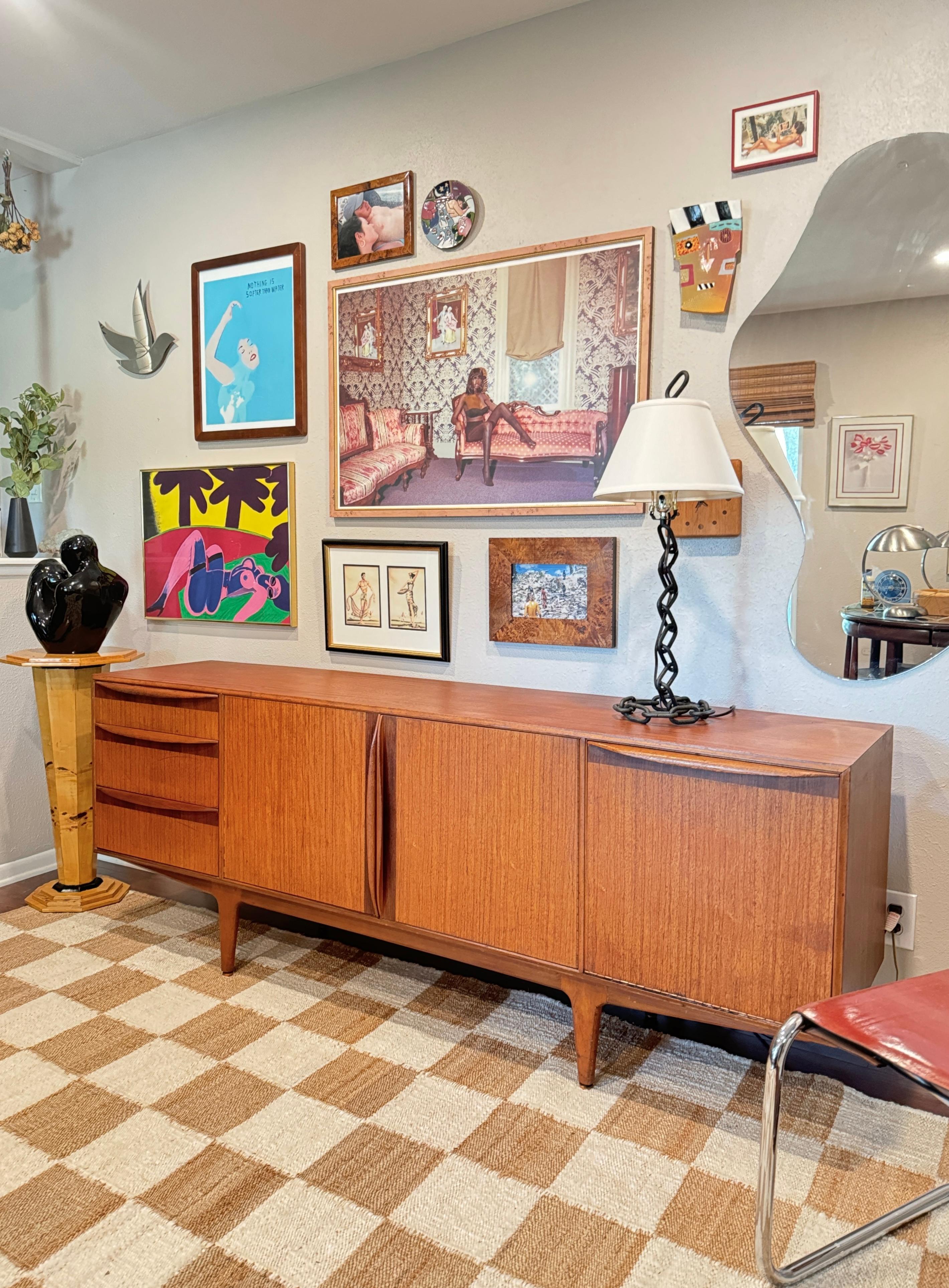 Mid Century Modern teak sideboard by Scottish Furniture Maker McIntosh. Beautiful wood grain, detailed cabinetmaking, and loads of storage make this a gem. Overall in good original condition. All doors open and close smoothly, and the piece is