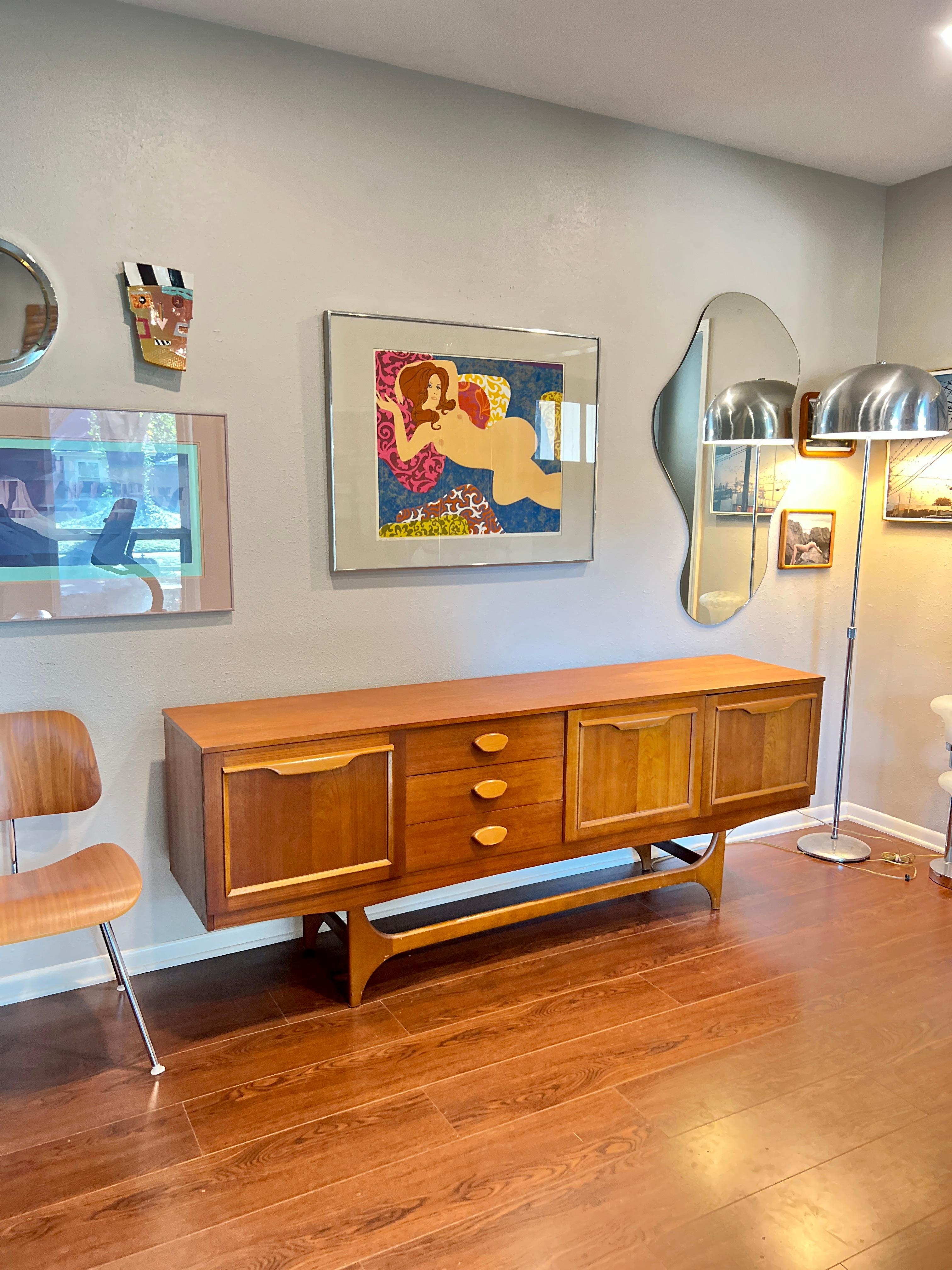 Mid century modern teak sideboard by Stonehill's Stateroom range, circa 1960s. Includes 2 end cupboards with a bank of 3 drawers and a pull down drinks cabinet. All drawers open and close smoothly and the sideboard is structurally sound. Some