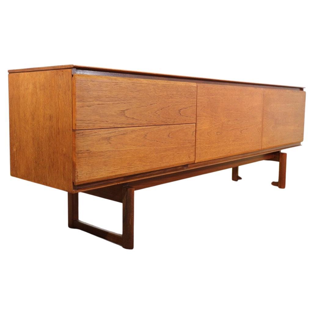 Produced by British furniture maker White & Newton of Portsmouth circa 1960s. White & Newton were the cutting edge of furniture design through out the 20th century in Britain. This fantastic linear teak sideboard designed by Philip Hussey for White