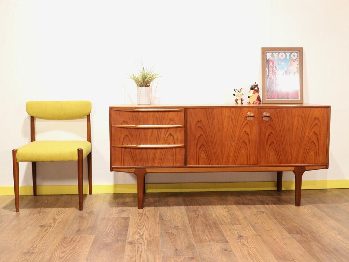 A.H. Mcintosh & CO. teak sideboard from the Dunfermline collection. Designed by Tom Robertson in the 1960's, it is a piece that perfectly combines all the functionality and design of mid 20th century sideboards. To its left, three drawers, of which
