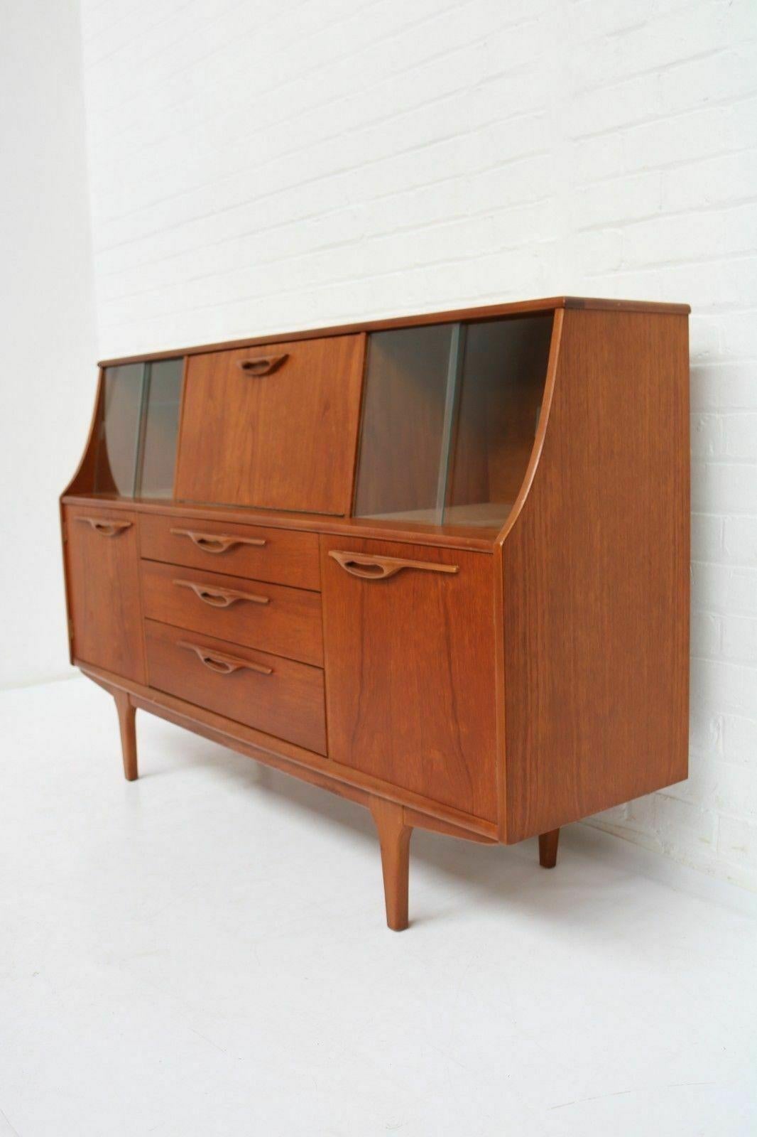 Mid-Century Modern teak sideboard - highboard - drinks cabinet by Jentique, England, 1960's

Jentique was a British company that made many quality pieces of furniture in the 1960s. Like other manufacturers of the time incorporating a Danish